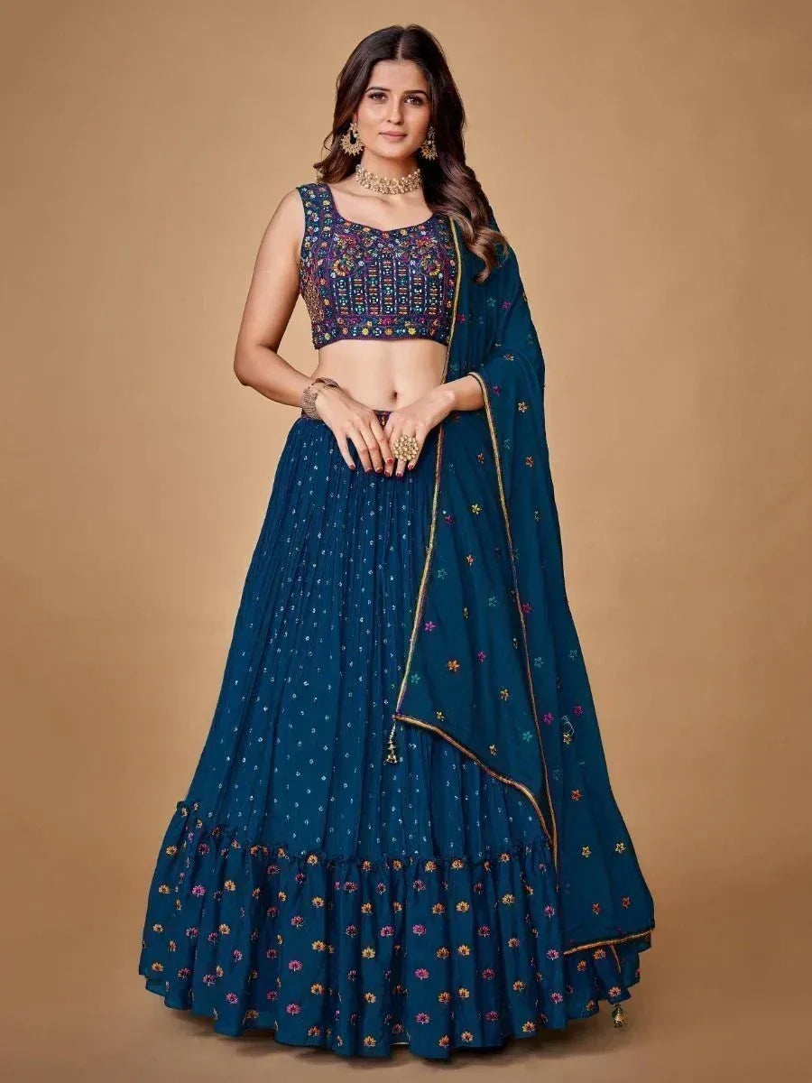 Teal embroidered lehenga choli with floral motifs and gold trim, perfect for Indian ethnic wear occasions