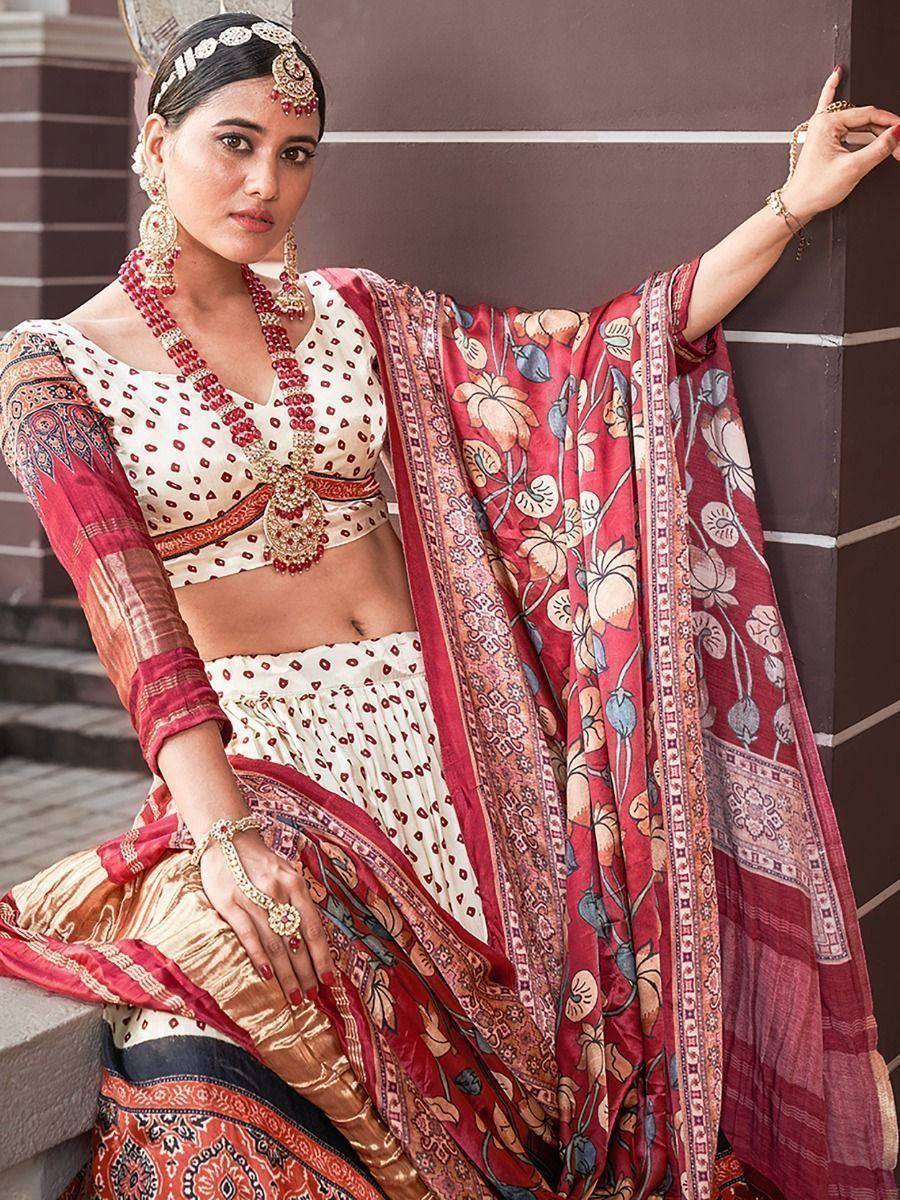 Woman in elegant red and cream printed lehenga choli with floral dupatta, traditional Indian ethnic wear