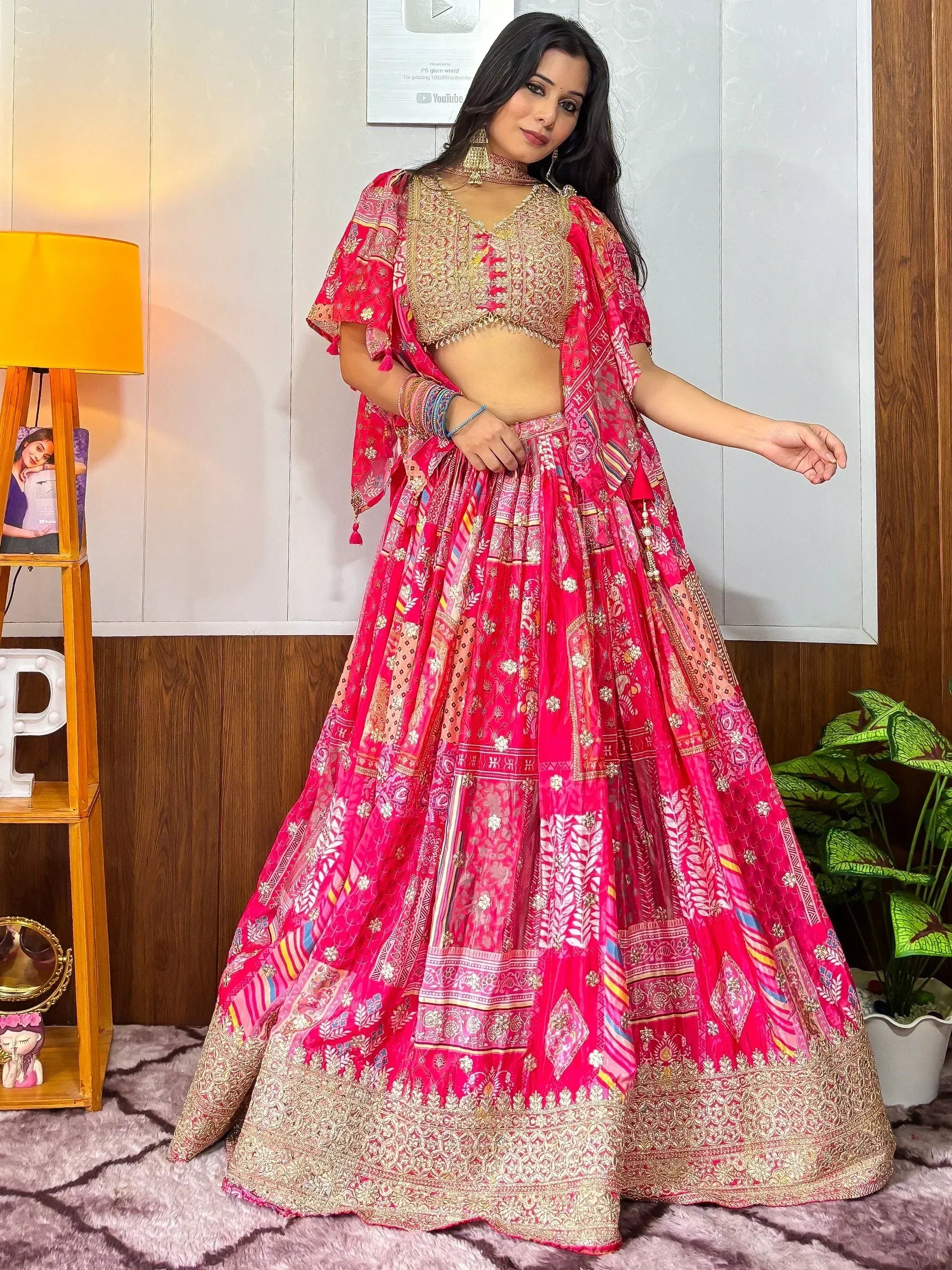 Vibrant pink printed lehenga choli with gold embroidery, perfect for Indian ethnic wear and festive occasions.