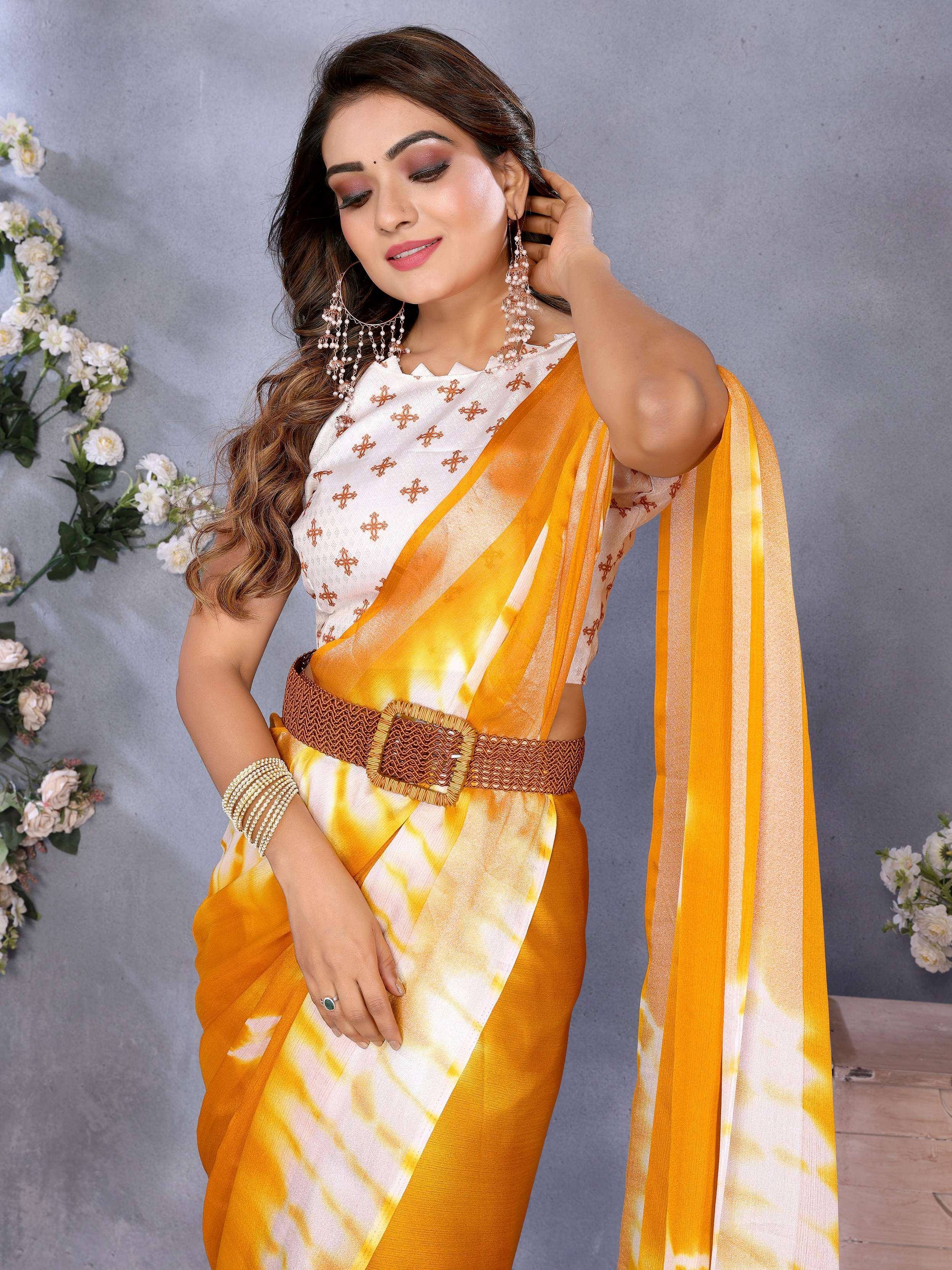 Yellow and white tie-dye saree with embroidered blouse and woven belt, styled with pearl jewelry