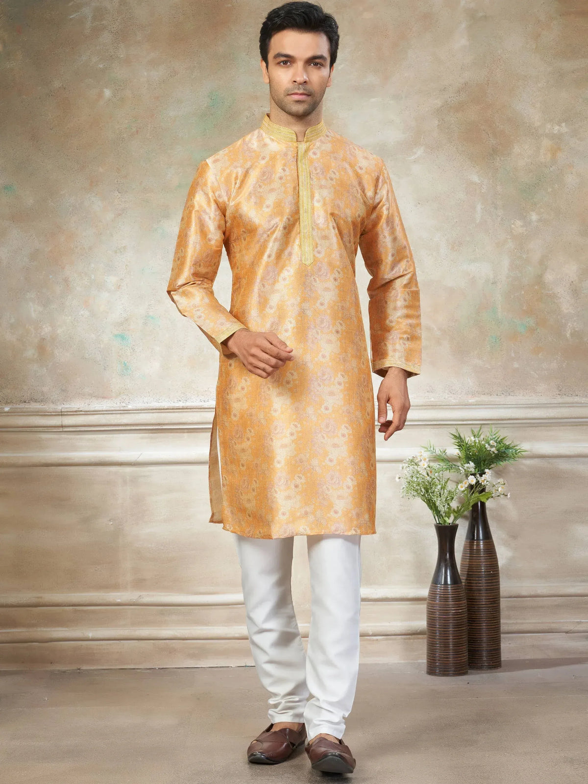 Men's golden floral kurta with white churidar, traditional Indian ethnic wear for festive occasions