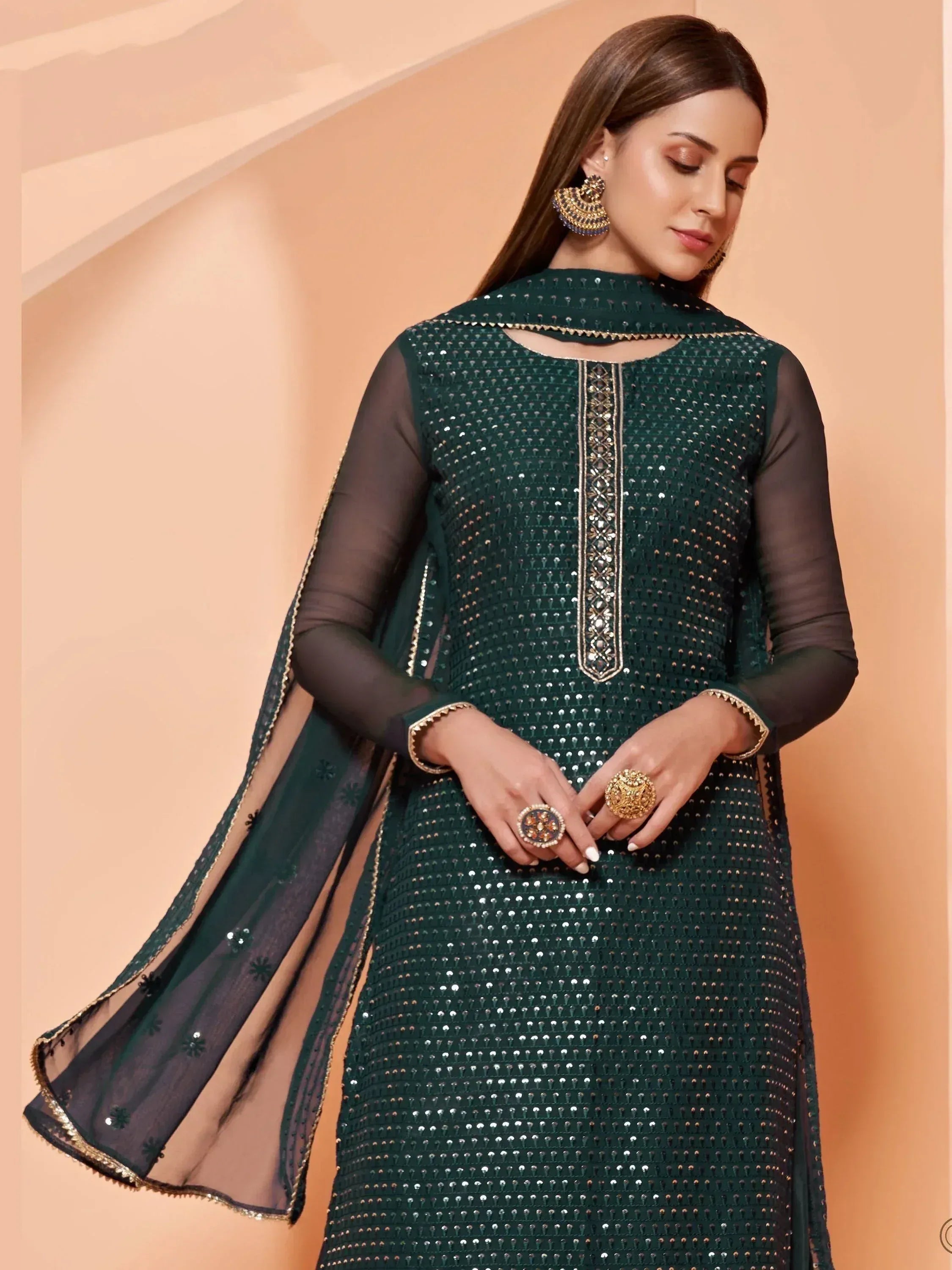 Emerald green sequined ethnic gown with sheer sleeves and gold embroidery, perfect for festive occasions.