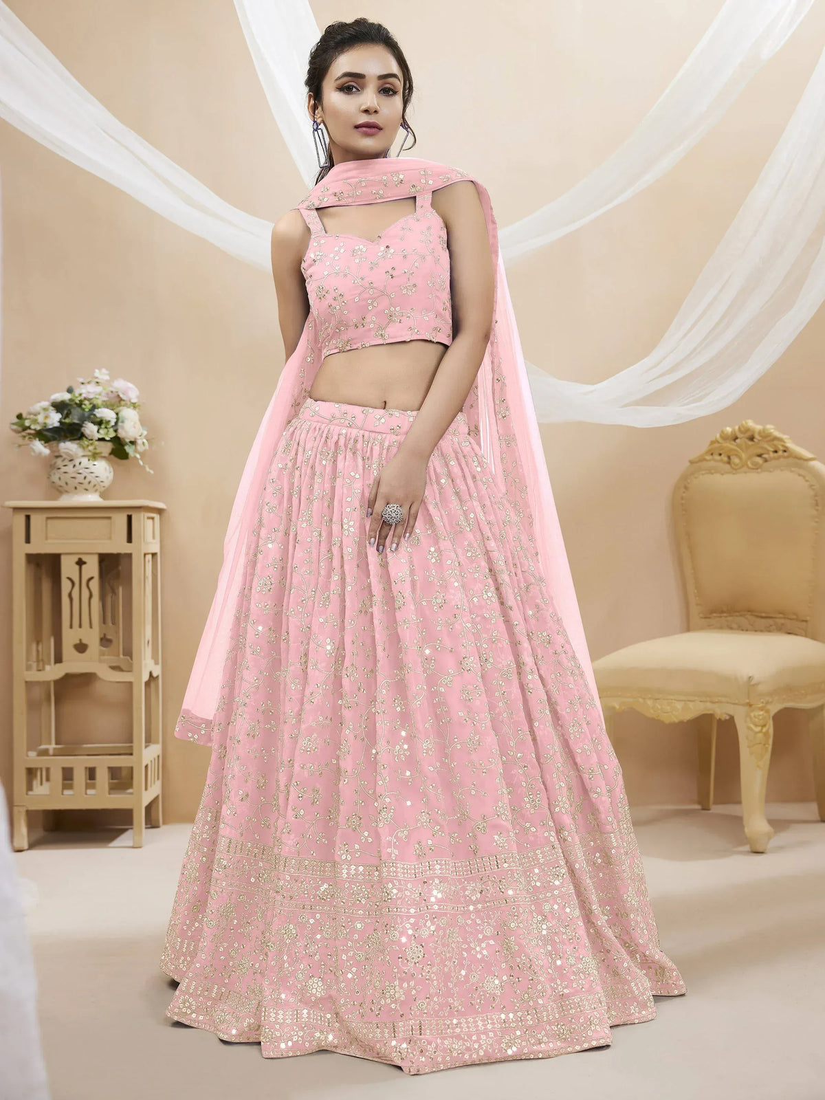 Pink embroidered lehenga choli with floral gold detailing and matching dupatta for Indian ethnic wear