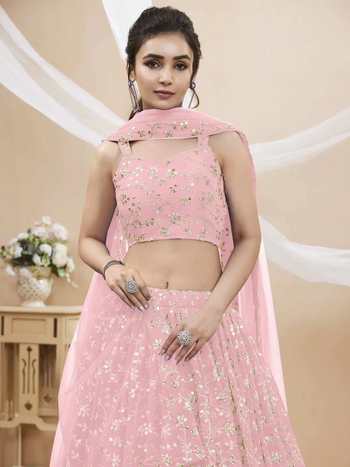 Pink floral embroidered lehenga choli with golden detailing for festive occasions