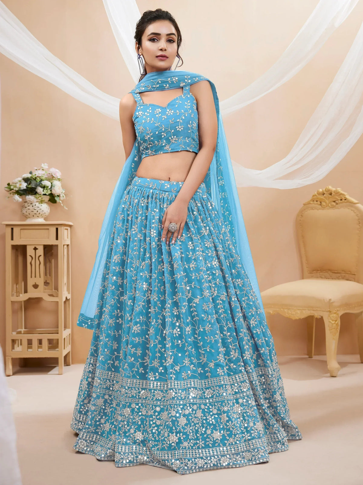 Blue embroidered lehenga choli with floral designs and matching dupatta for ethnic wear