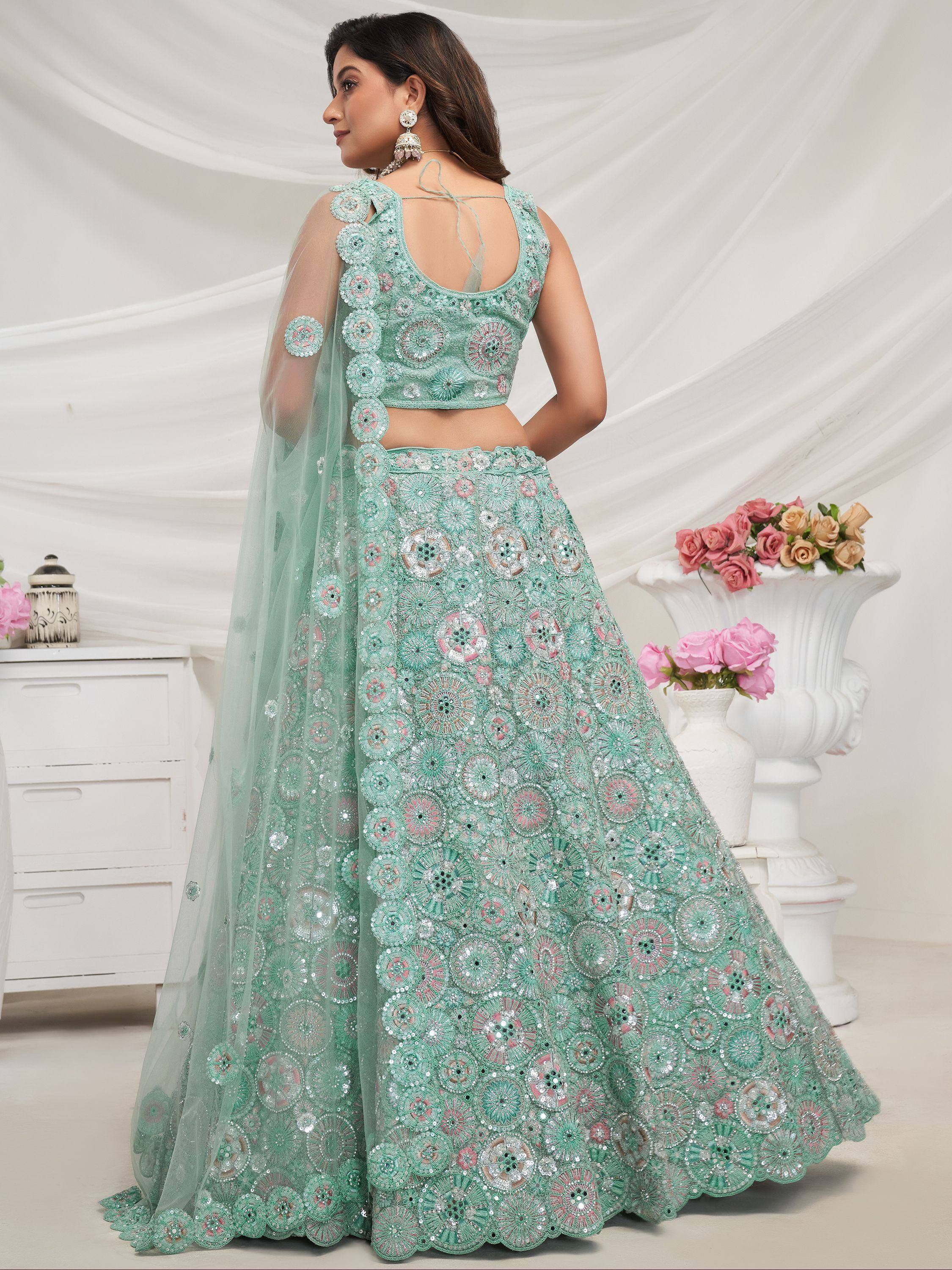 Mint green designer lehenga choli with floral embroidery and sequins, perfect for Indian weddings and parties