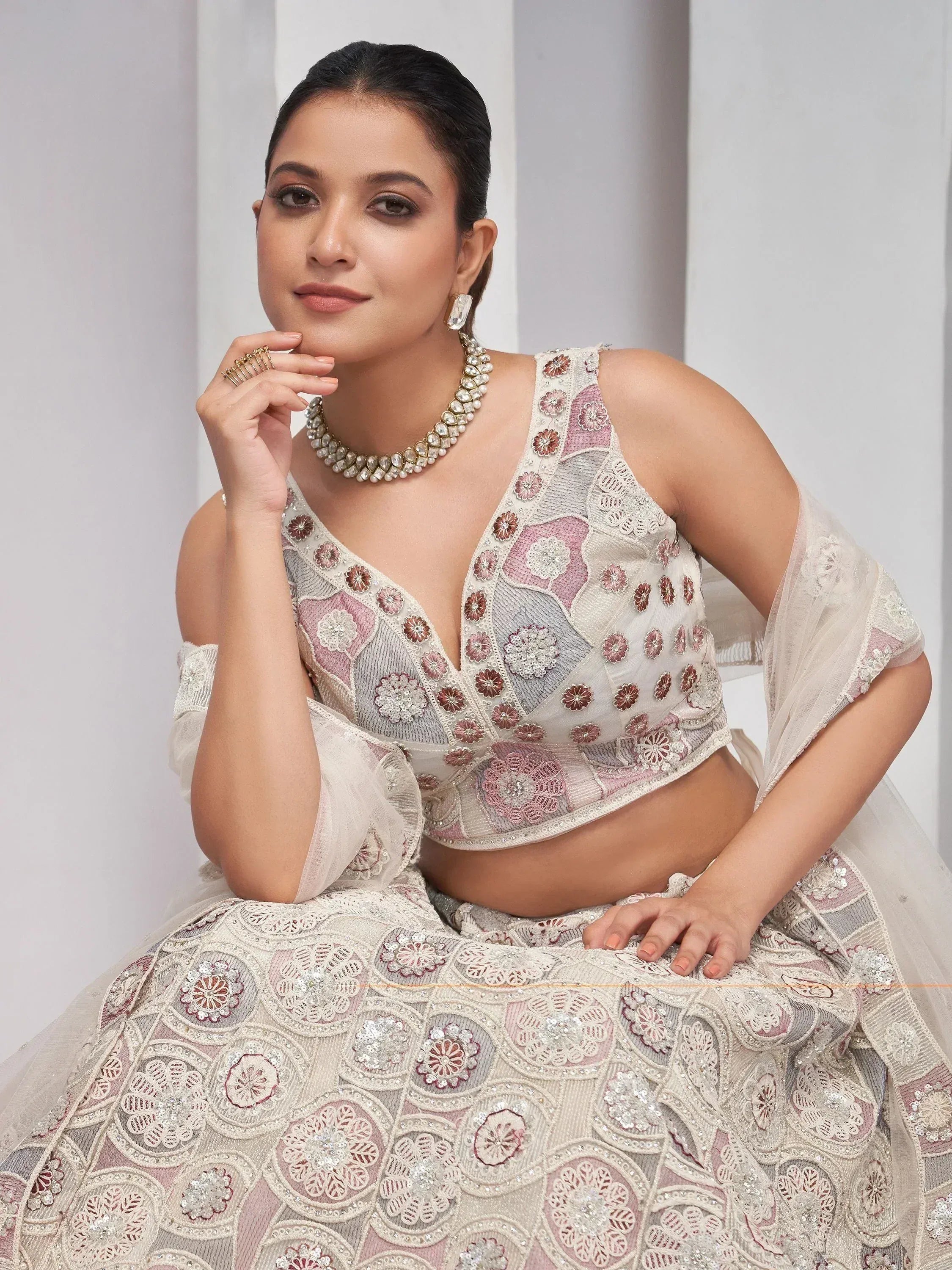 Elegant floral embroidered lehenga choli with pearl jewelry for Indian ethnic wear