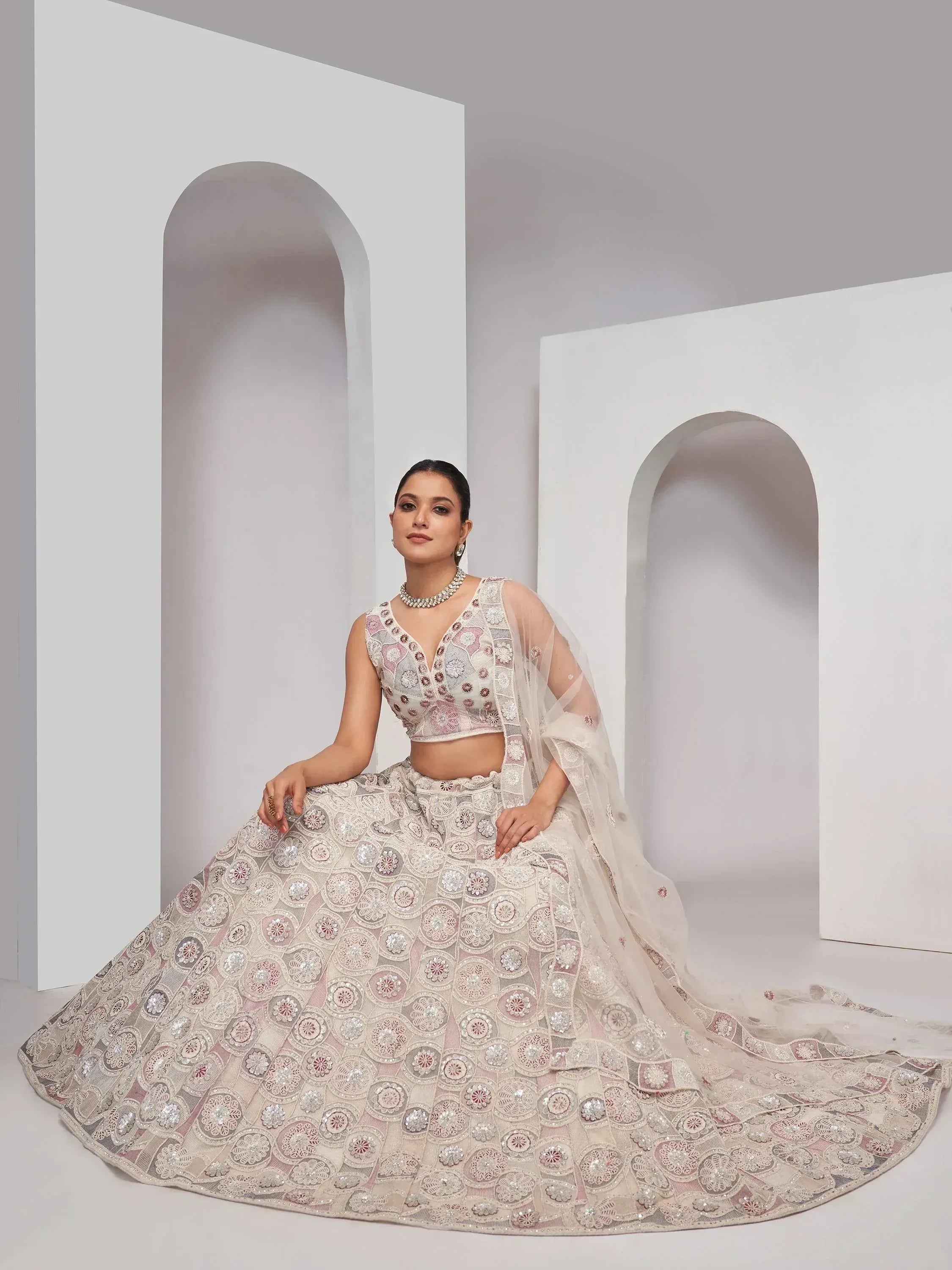 Elegant designer lehenga choli with intricate floral embroidery and sheer dupatta, perfect for Indian ethnic wear.