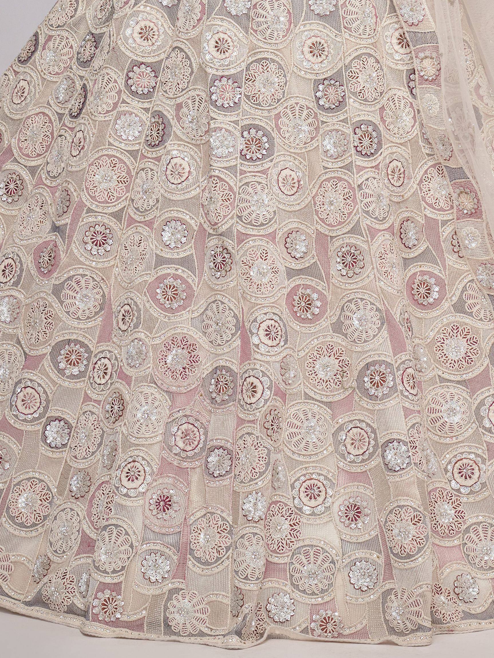 Elegant ethnic lehenga with intricate floral embroidery and sequin detailing in soft pastel tones