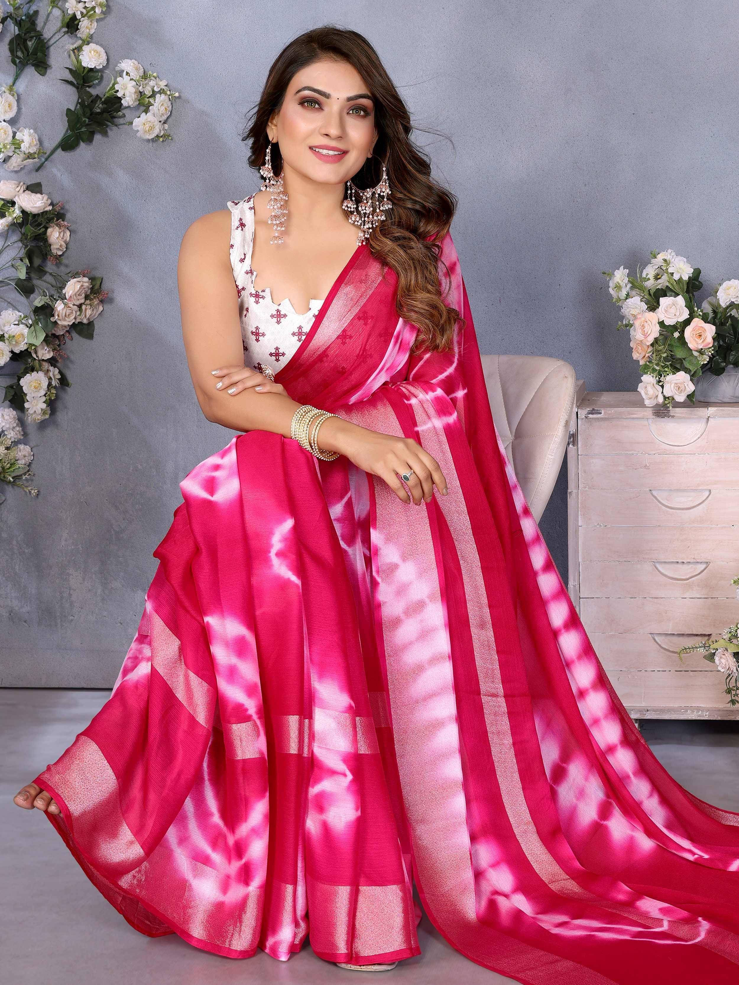 Woman in vibrant pink tie-dye saree with white embroidered blouse, styled for Indian ethnic wear