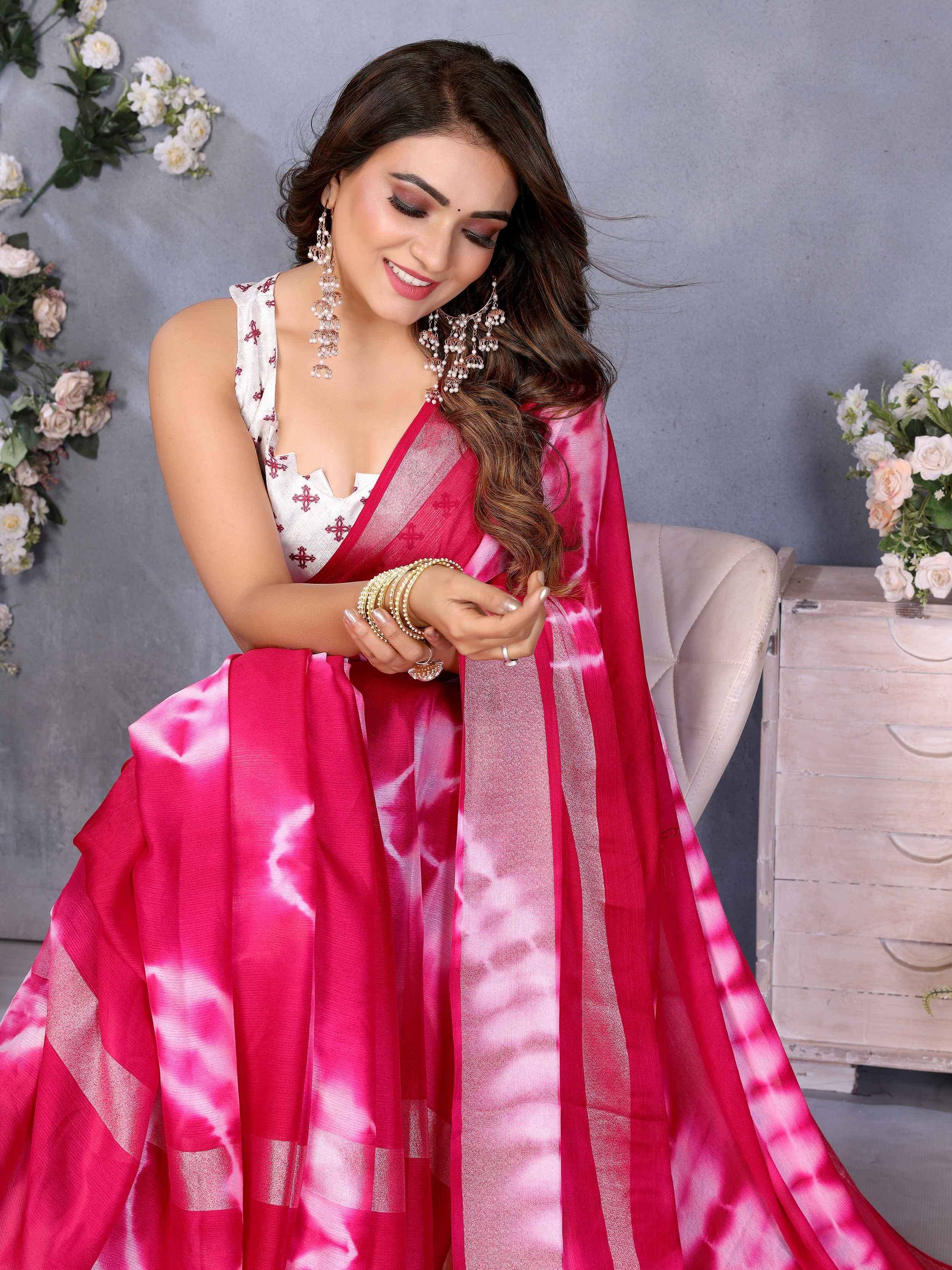 Woman in pink tie-dye saree with white embroidered blouse, traditional Indian ethnic wear
