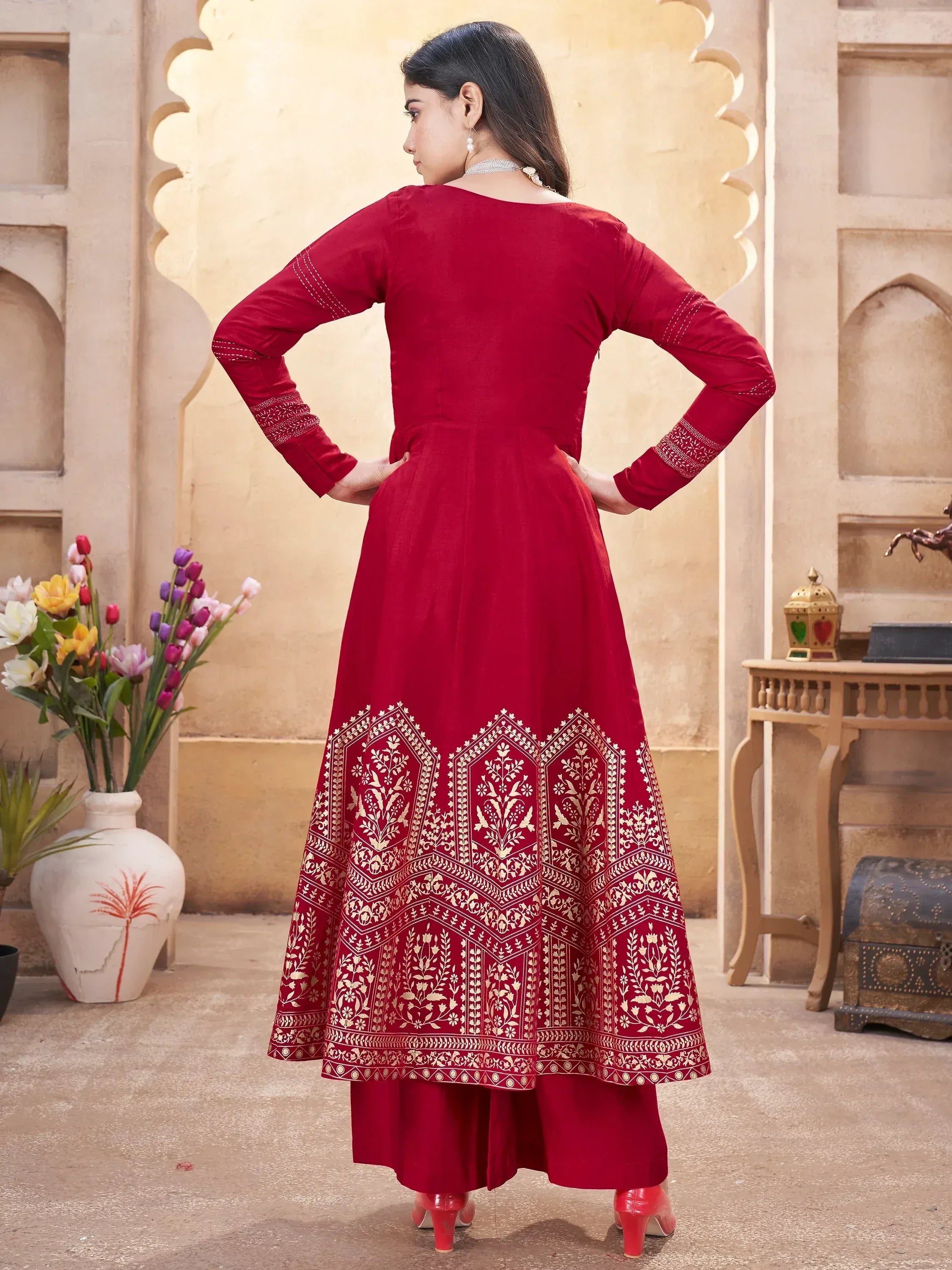 Red ethnic anarkali suit with gold embroidery, perfect for Indian weddings and festive occasions