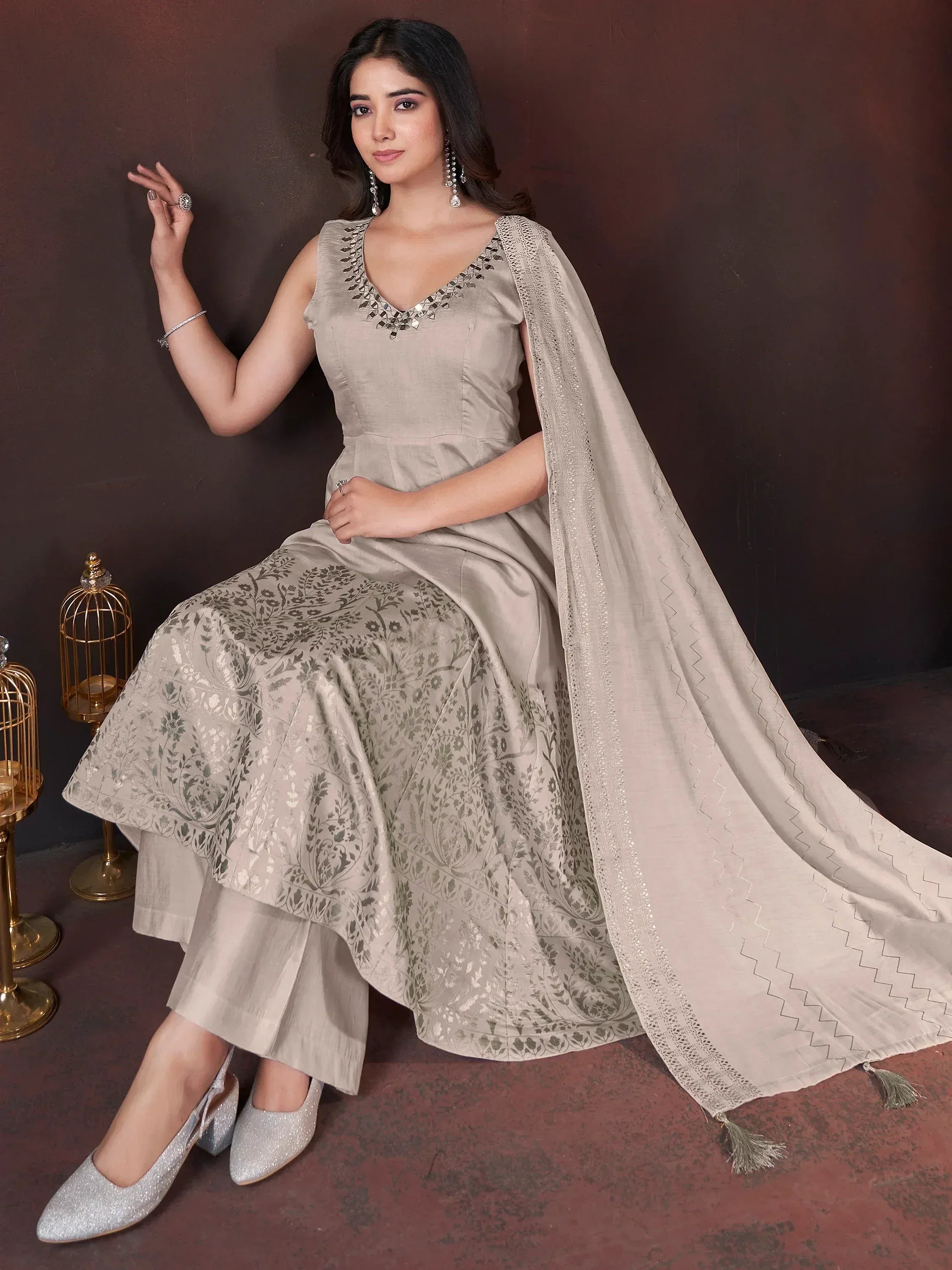 Beige floral print ethnic gown with mirror work neckline and matching dupatta, styled with silver heels