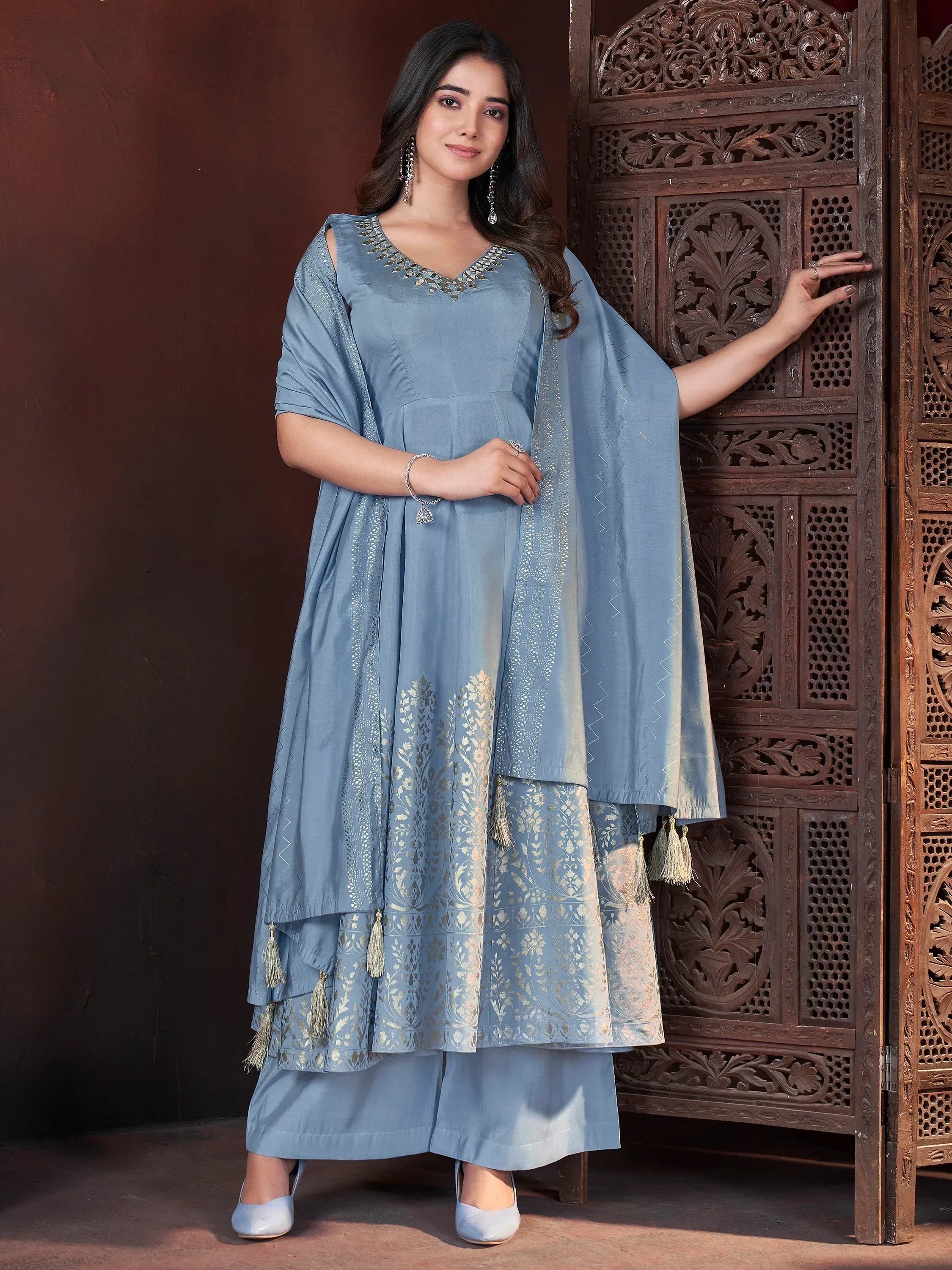 Blue ethnic anarkali suit with gold embroidery and tassels, perfect for Indian occasions