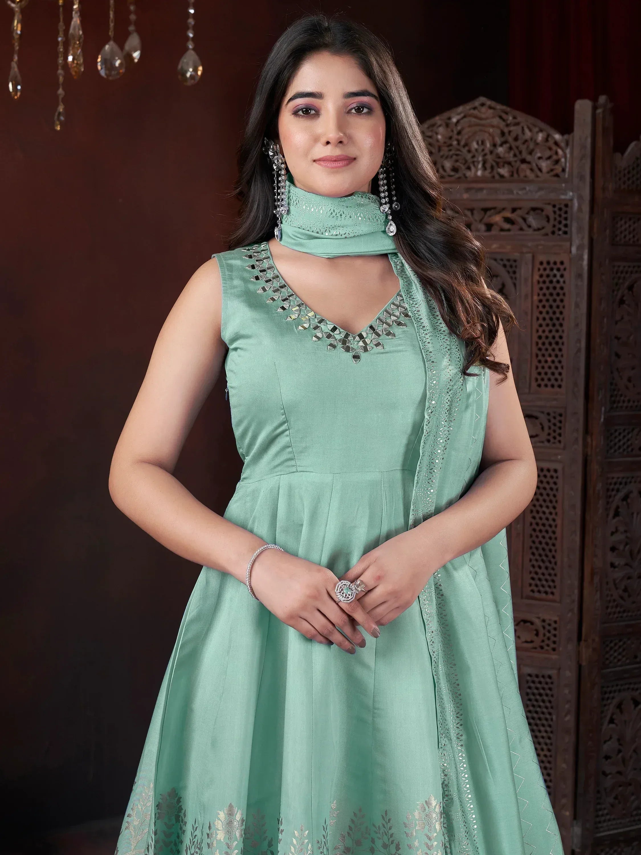 Mint green ethnic gown with mirror work, perfect for Indian weddings and parties. Stylish designer wear.