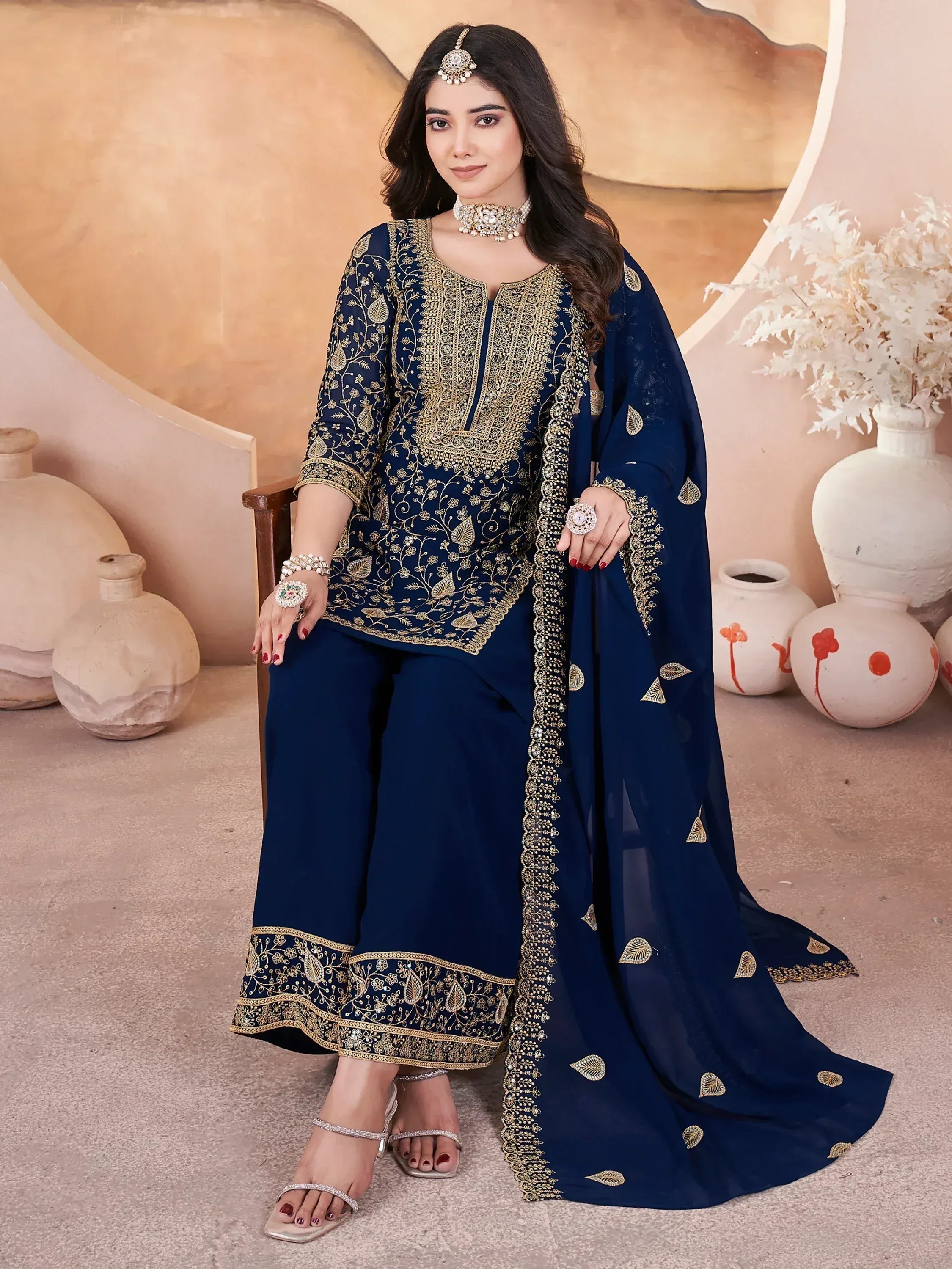 Elegant navy blue salwar kameez with gold embroidery and matching dupatta, perfect for Indian ethnic occasions.