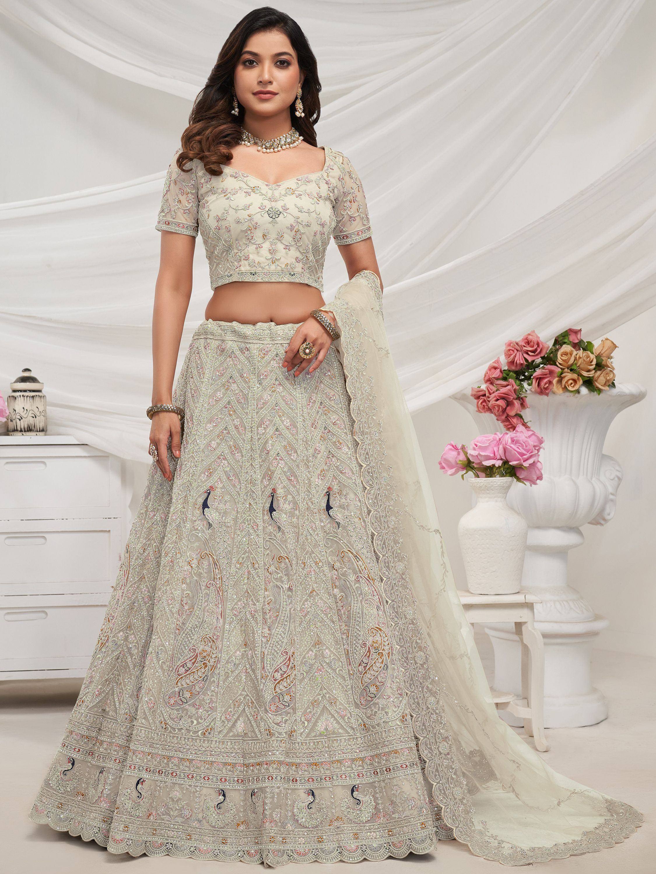 Elegant ivory lehenga choli with peacock embroidery, perfect for Indian weddings and festive occasions.