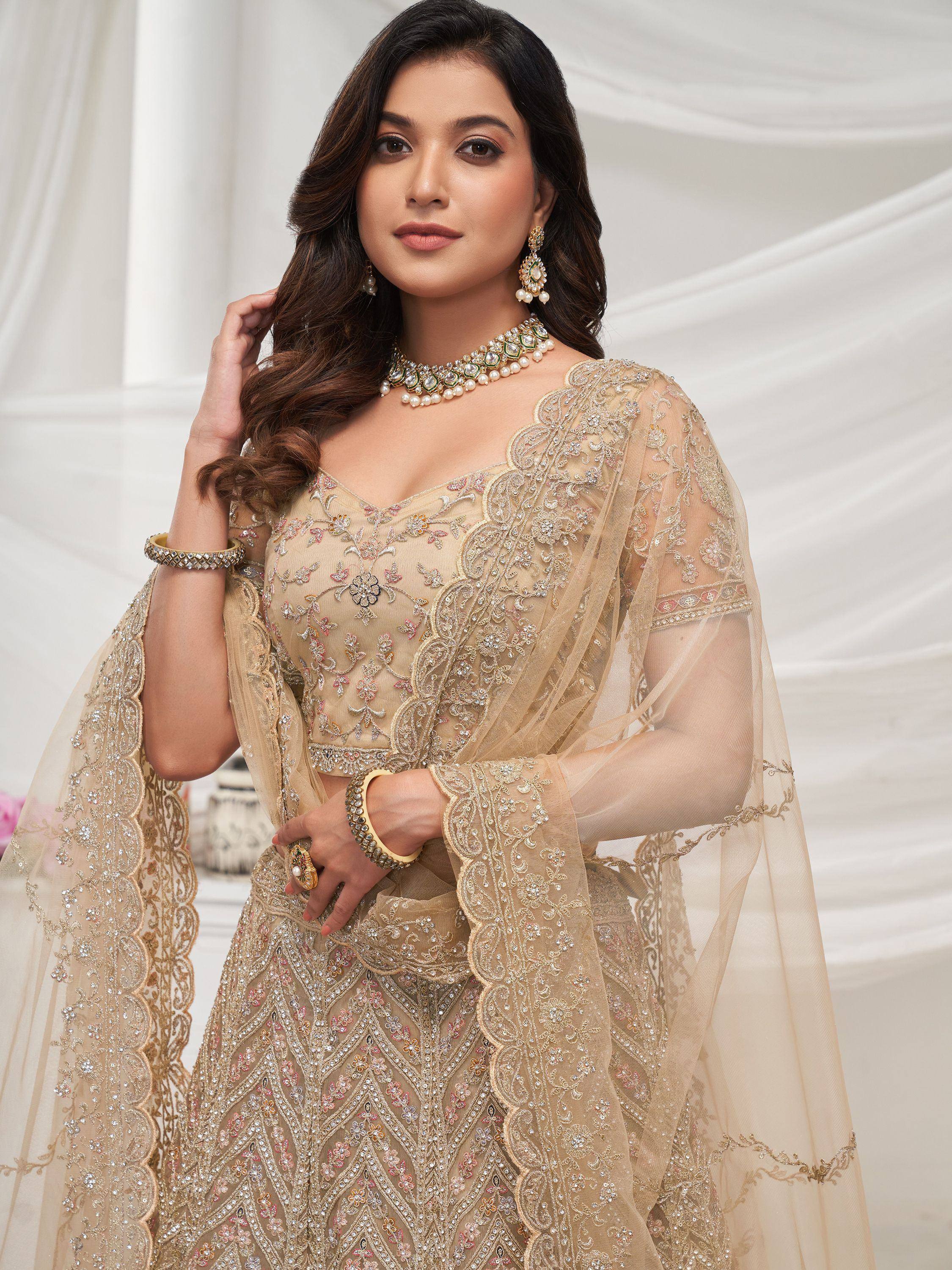 Elegant beige embroidered lehenga choli with sheer dupatta, perfect for Indian ethnic occasions
