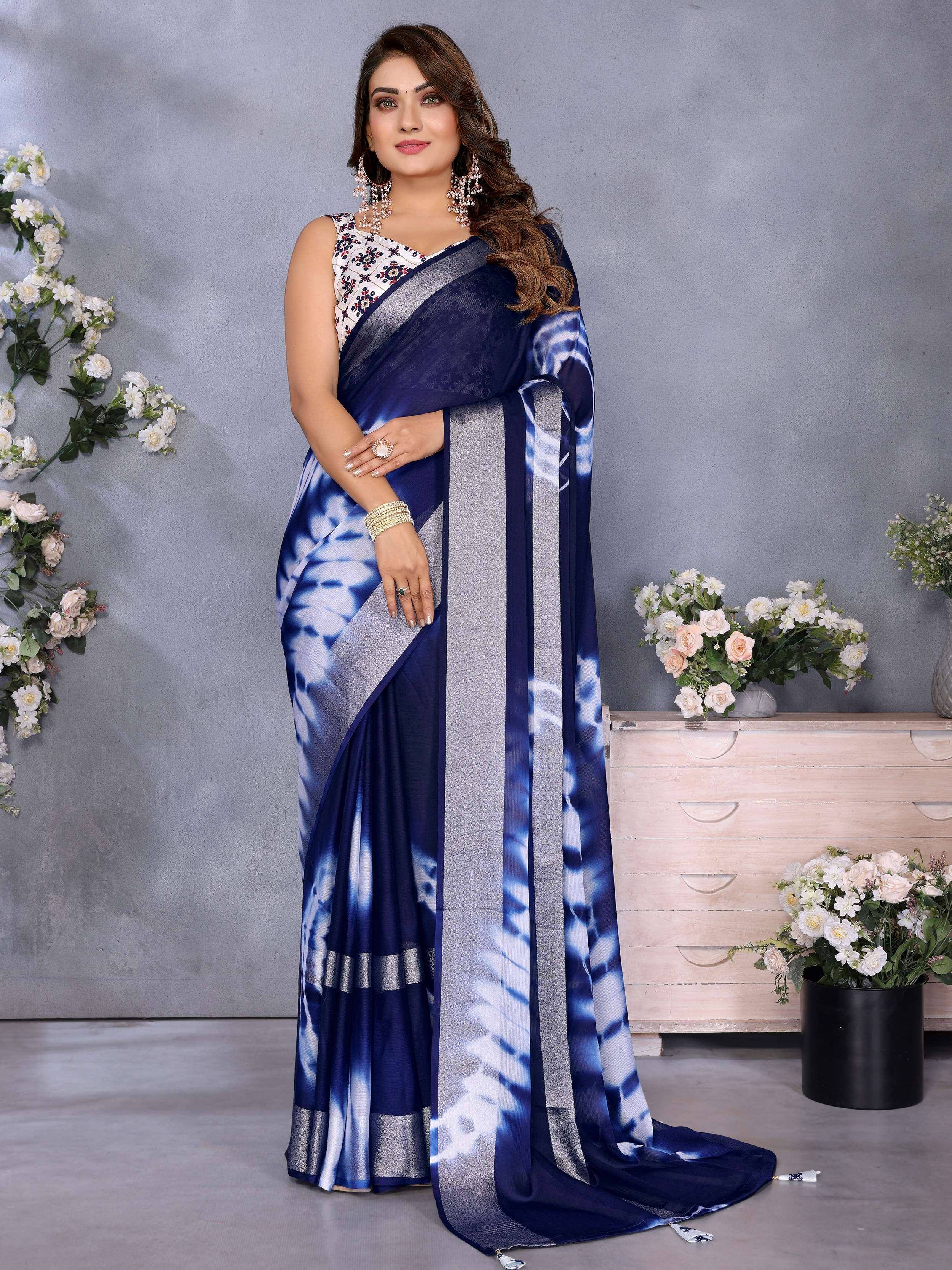 Navy blue tie-dye saree with silver border, paired with floral blouse, perfect for ethnic occasions.