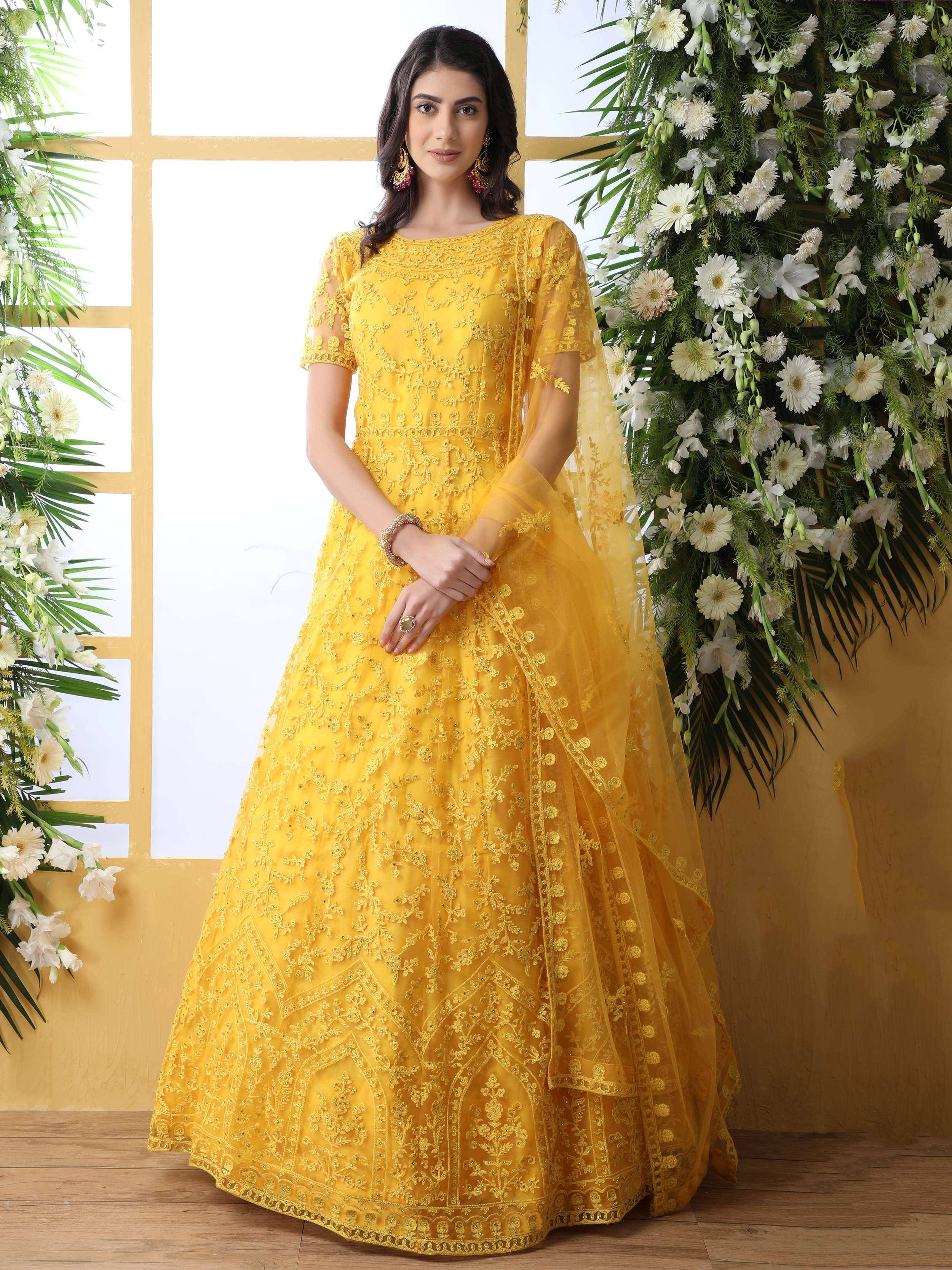 Yellow embroidered lehenga choli with floral detailing, perfect for Indian ethnic occasions and weddings.