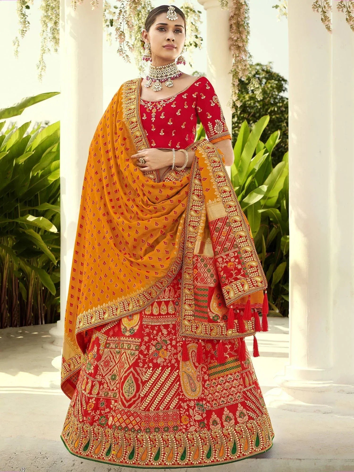 Red and gold embroidered lehenga choli with matching dupatta, perfect for Indian weddings and festive occasions.