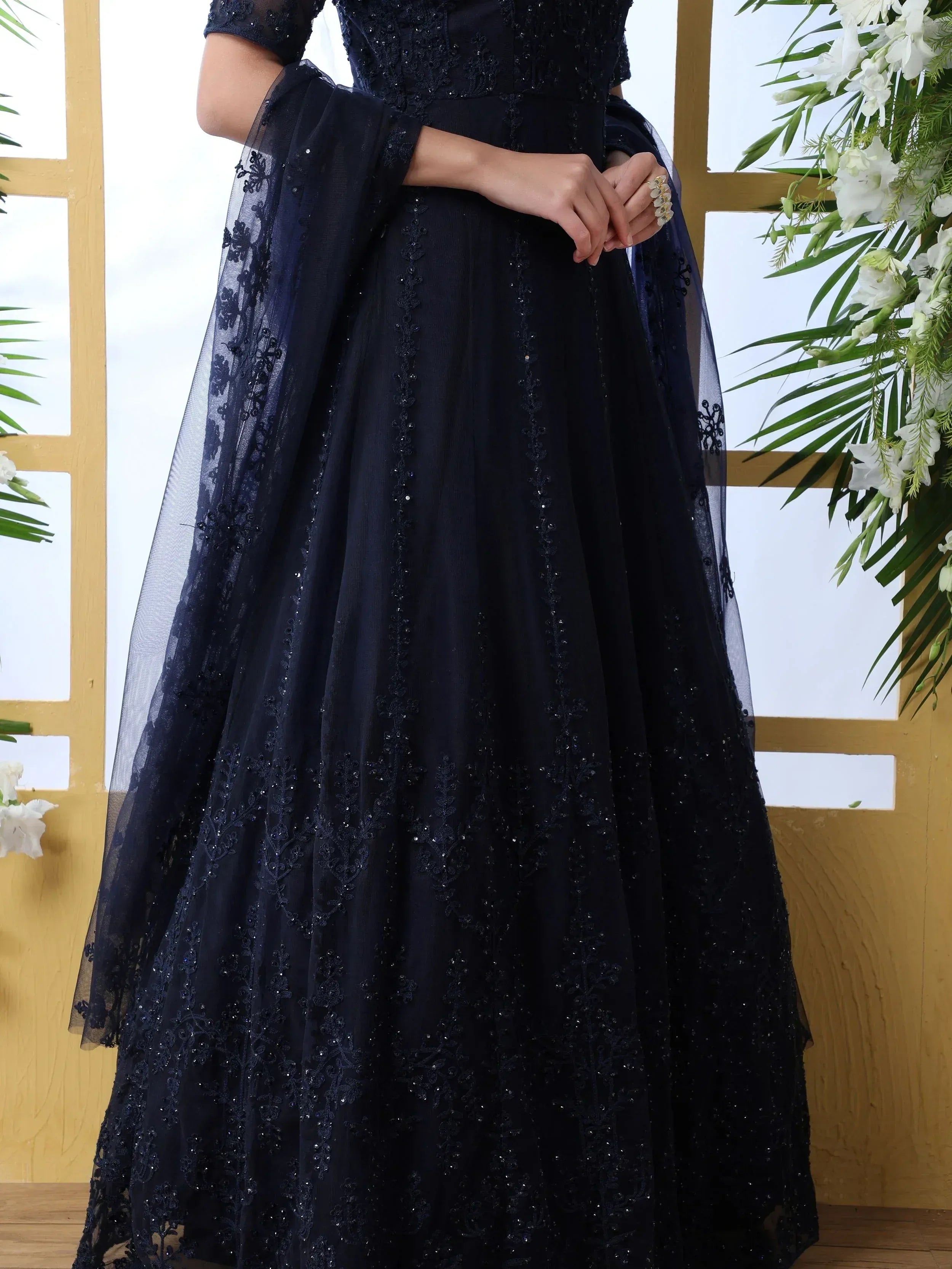 Navy blue embroidered ethnic gown with sheer sleeves and floral lace detailing, perfect for weddings and parties.