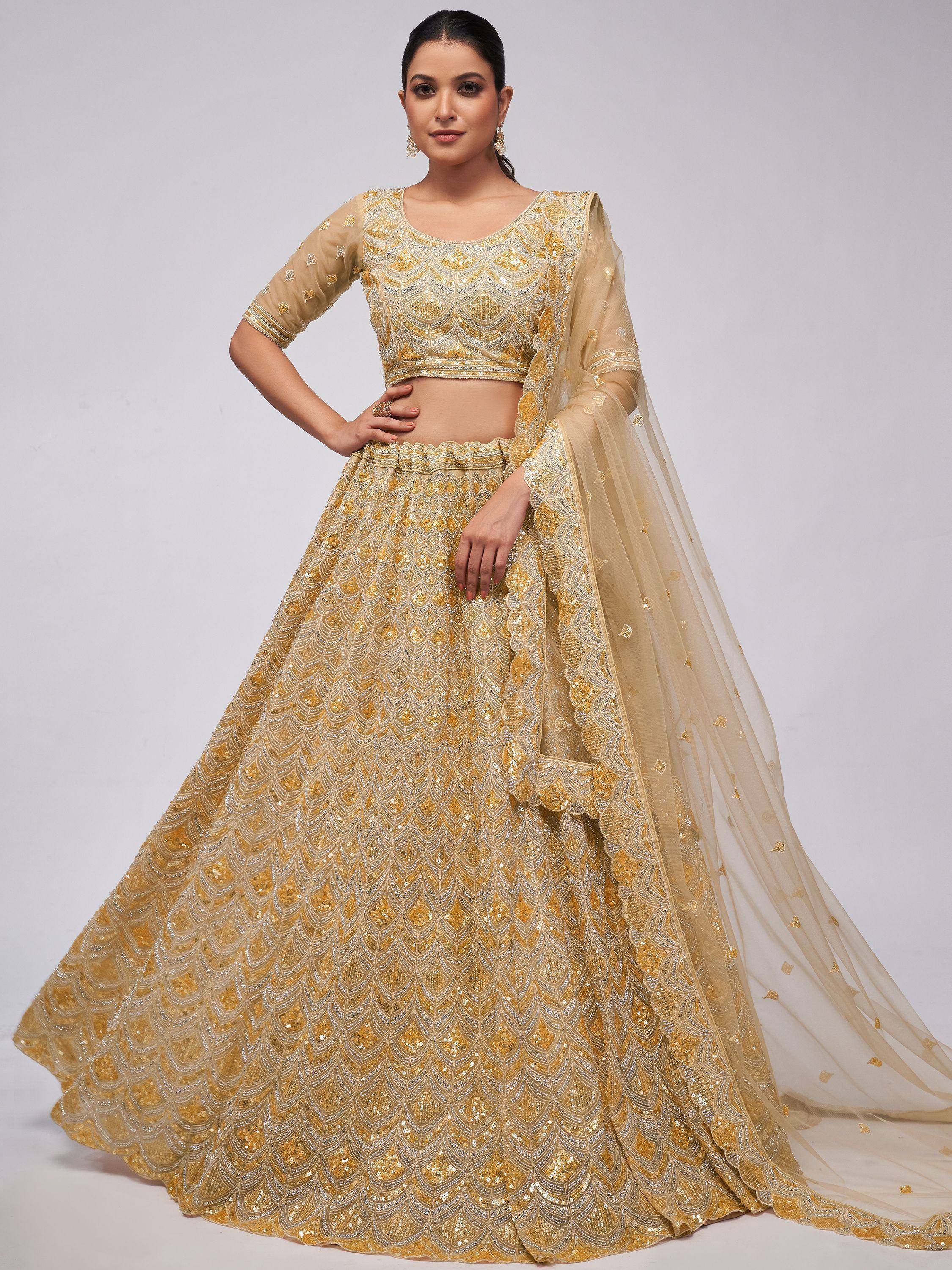 Golden embroidered lehenga choli with sheer dupatta, perfect for Indian weddings and festive occasions