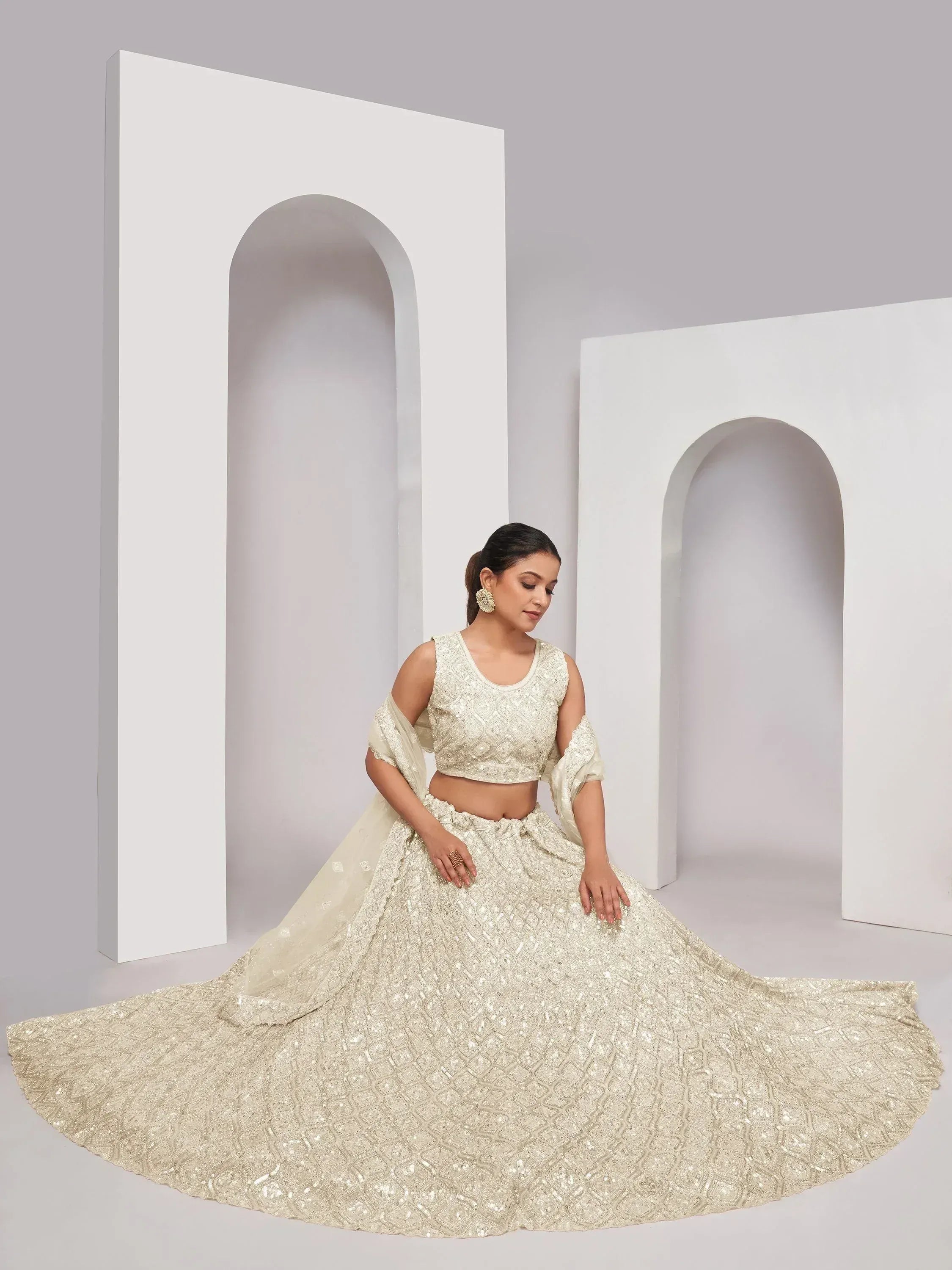 Elegant ivory lehenga choli with intricate embroidery, perfect for Indian weddings and festive occasions.