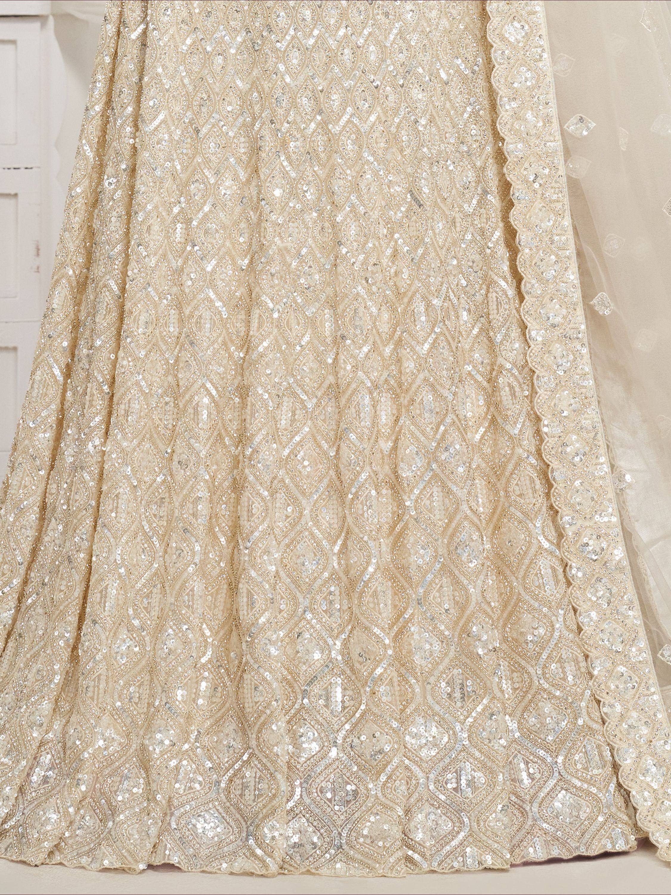 Ivory designer lehenga with intricate sequin and beadwork, perfect for Indian weddings and ethnic events