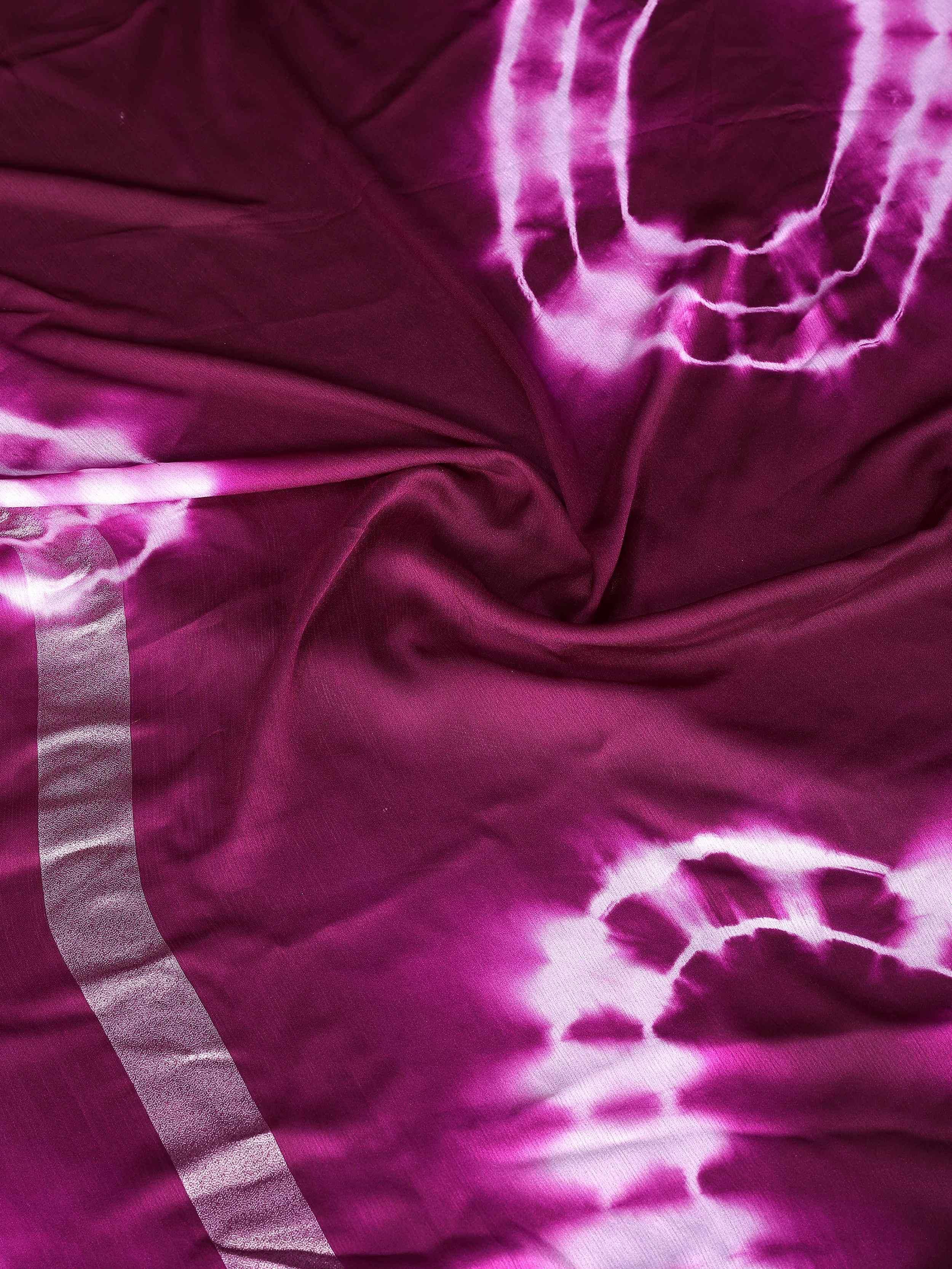 Purple tie-dye ethnic saree with shimmering border, perfect for Indian festive wear