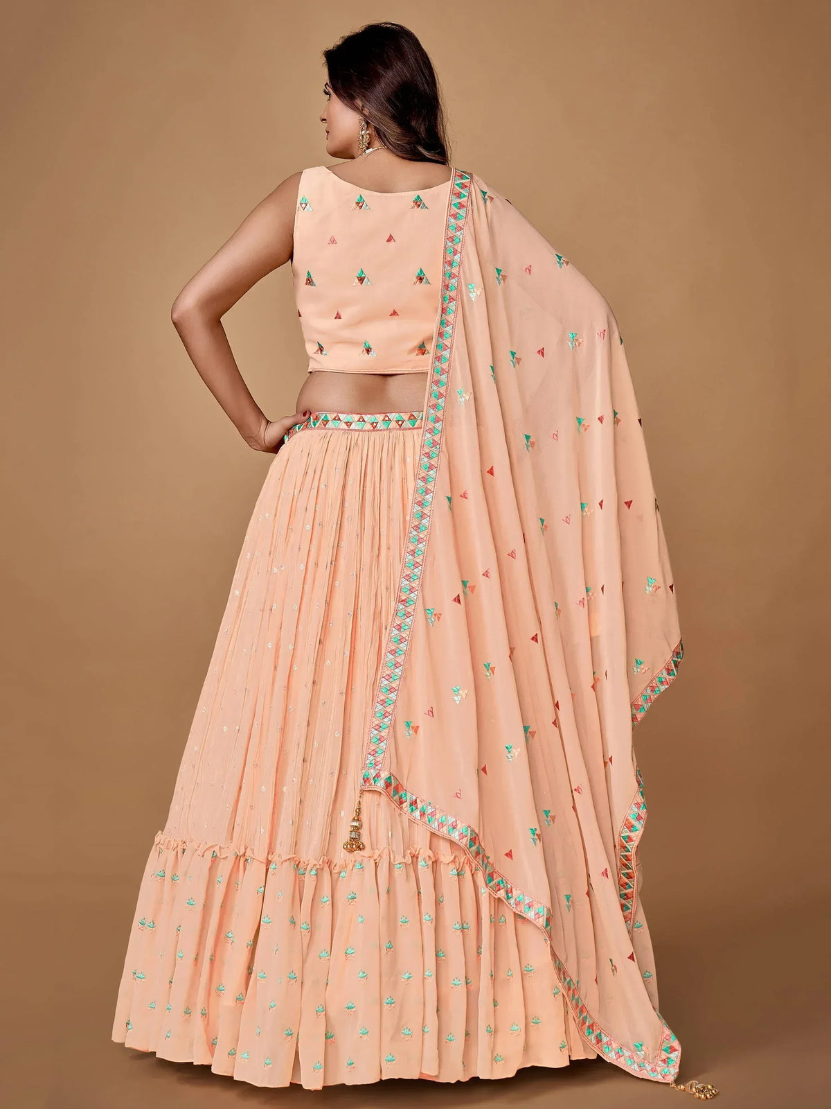 Peach lehenga choli with geometric embroidery and matching dupatta for ethnic wear