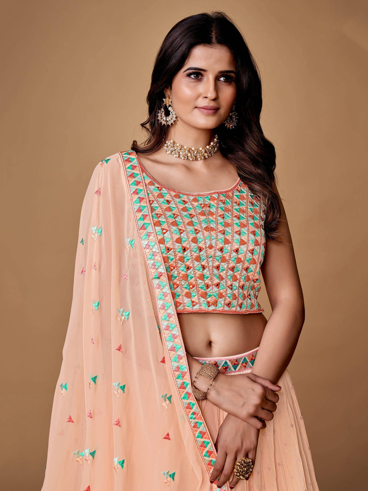 Elegant peach lehenga choli with geometric embroidery and matching dupatta for Indian ethnic wear