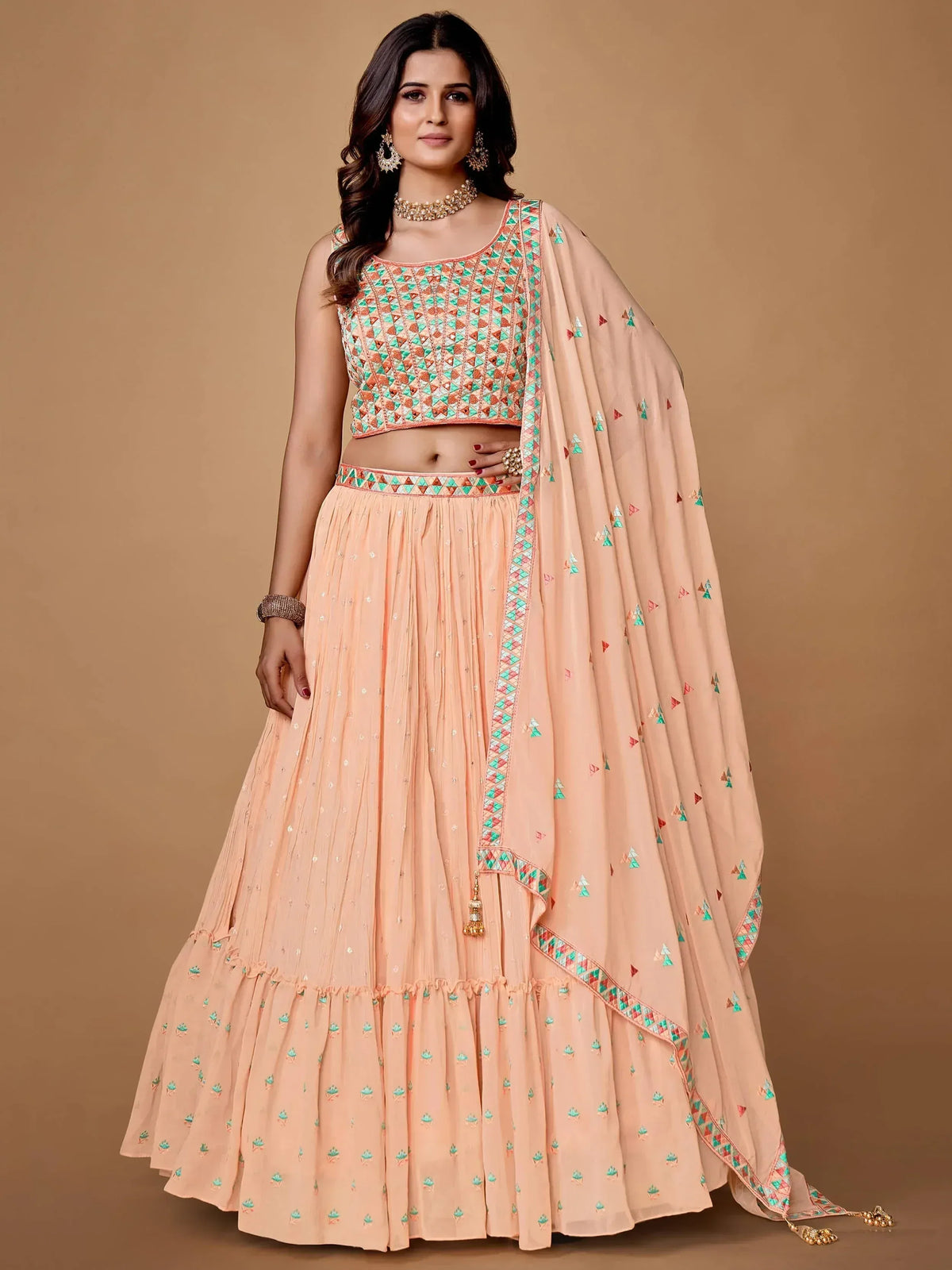 Peach lehenga choli with geometric embroidery, perfect for Indian ethnic wear and festive occasions.