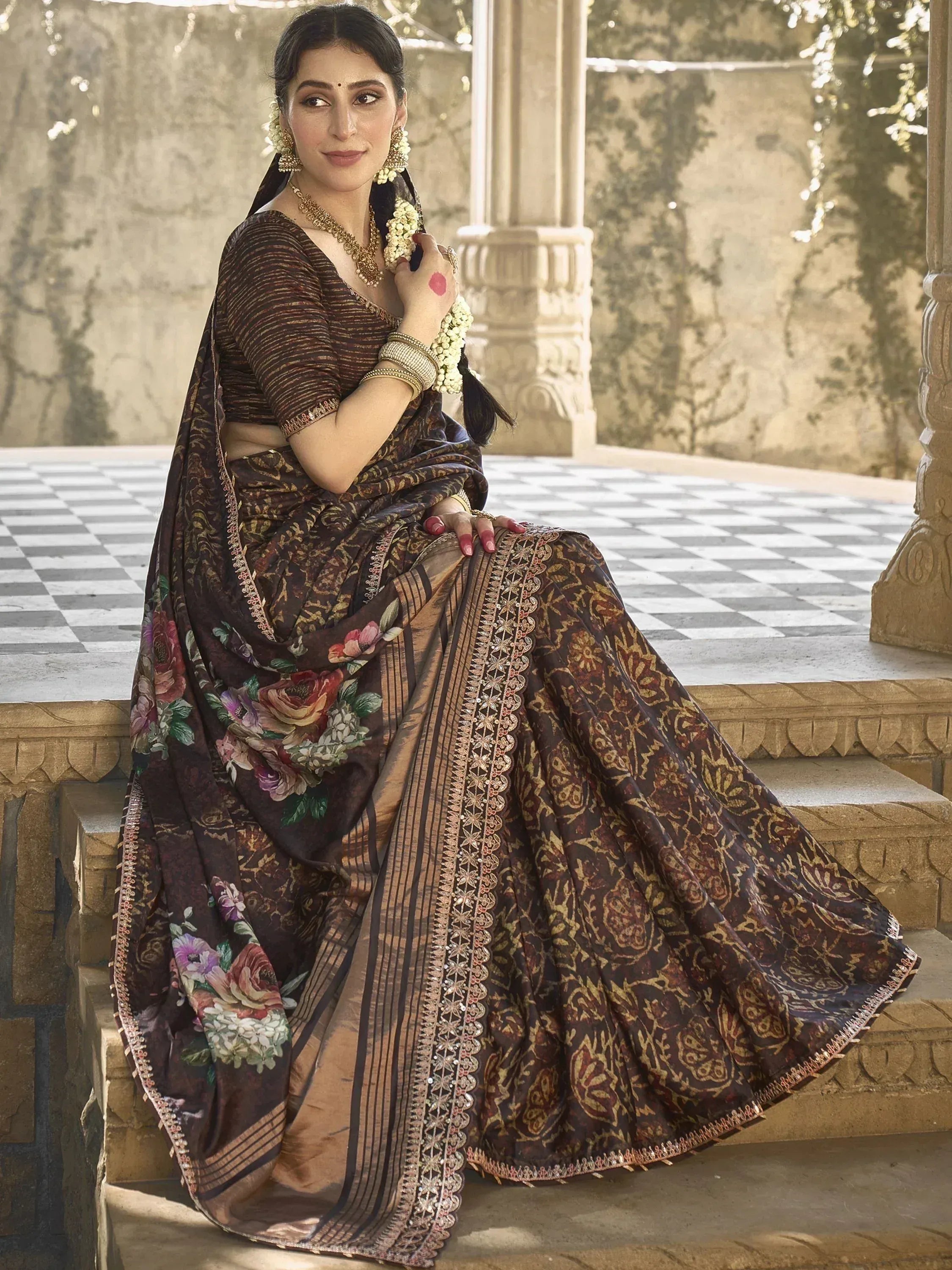 Woman in elegant brown floral saree with gold embroidery, traditional Indian ethnic wear
