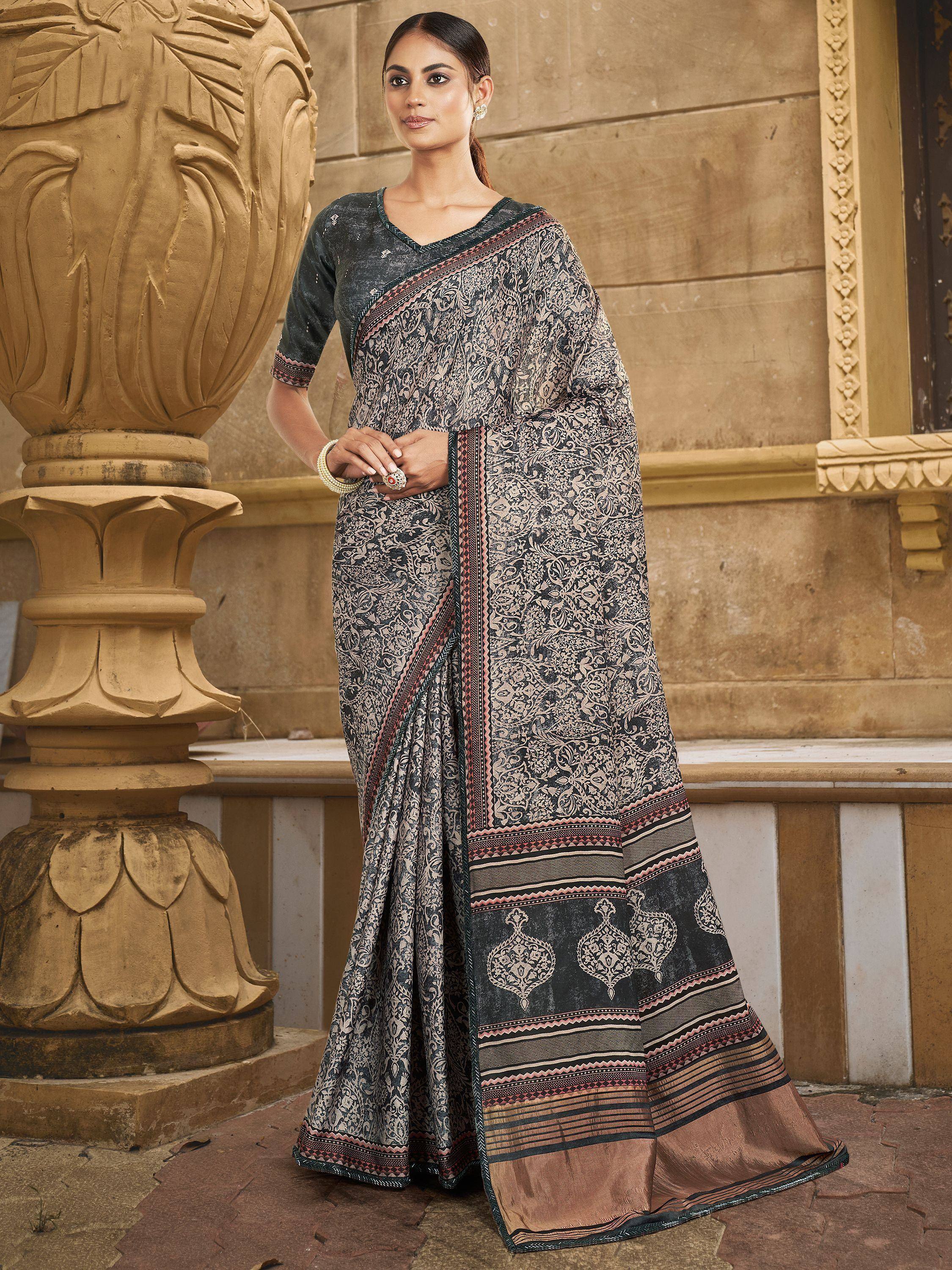 Woman in elegant black and beige printed saree with intricate border, styled with matching blouse for ethnic occasions