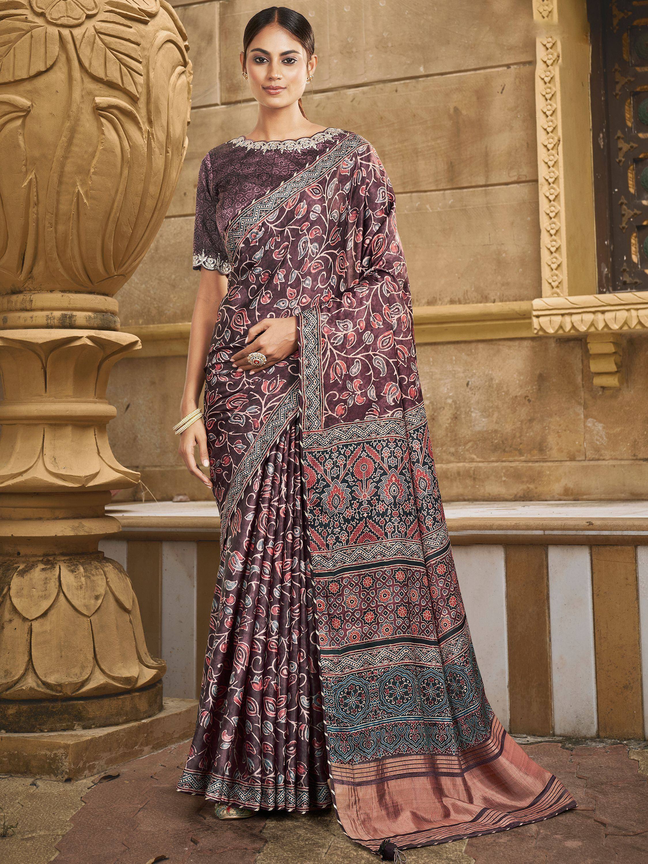 Woman in elegant purple floral print saree with embroidered border, traditional Indian ethnic wear