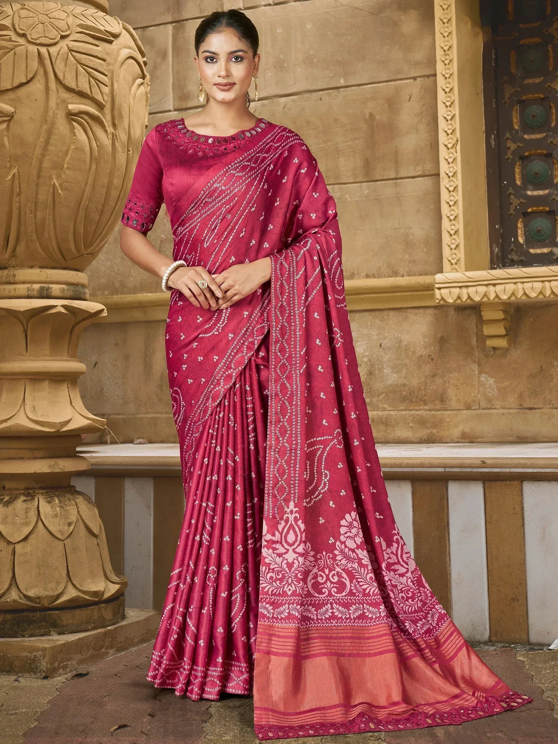 Elegant maroon saree with white bandhani print and floral border, paired with mirror-work blouse for Indian ethnic wear