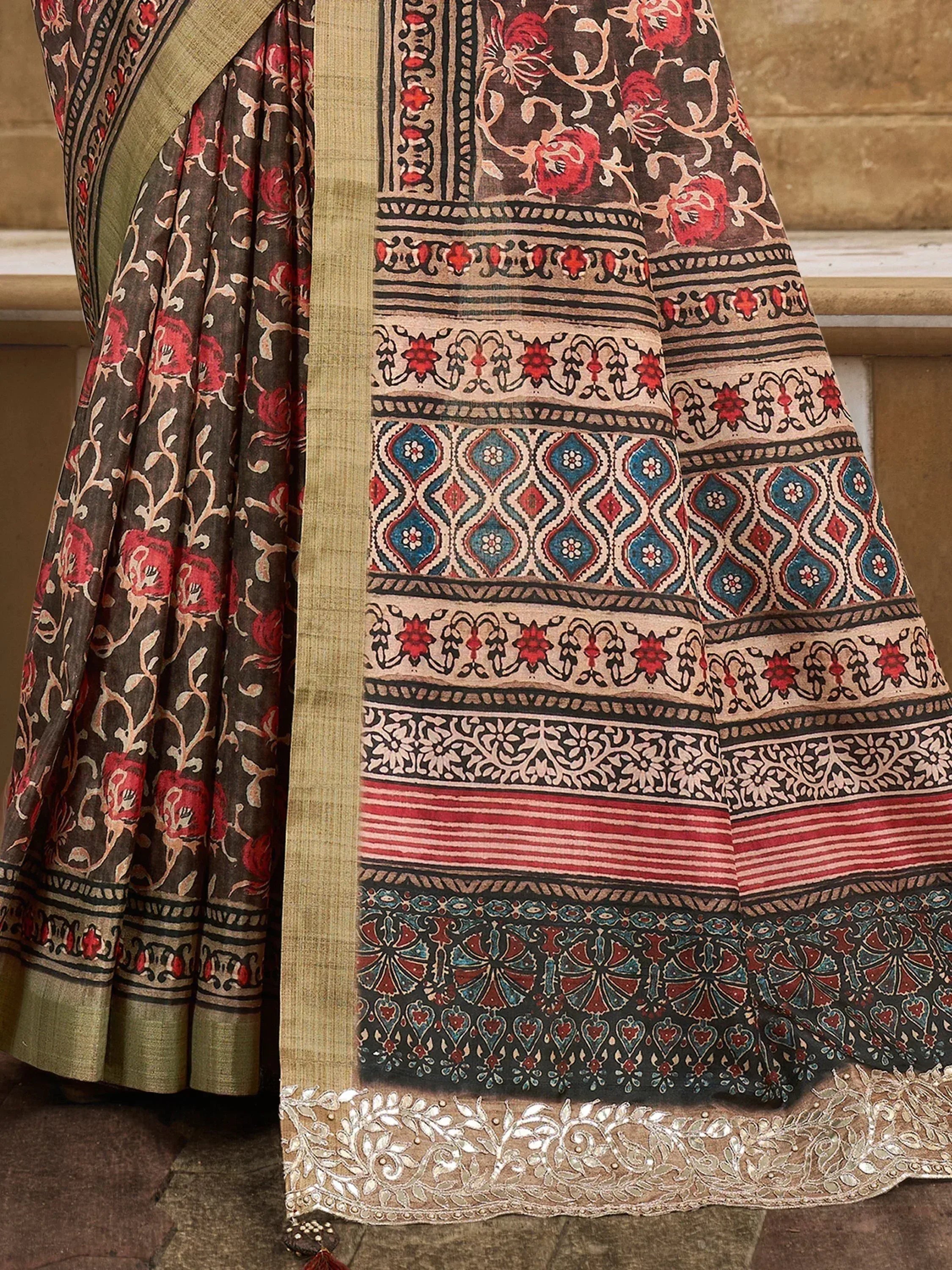 Indian ethnic saree with floral and geometric print, gold border, and sequin detailing for festive occasions