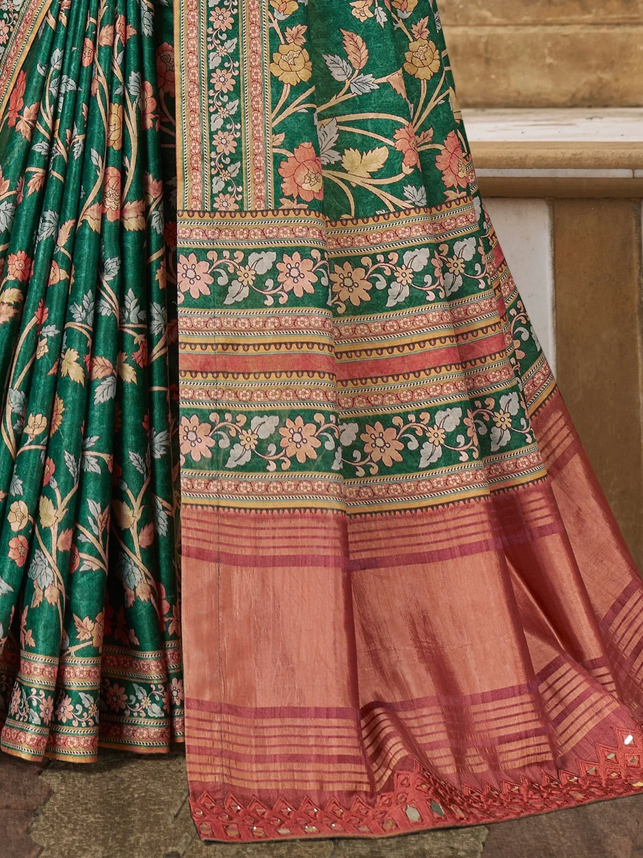 Green floral saree with intricate border and pink pallu, perfect for ethnic occasions