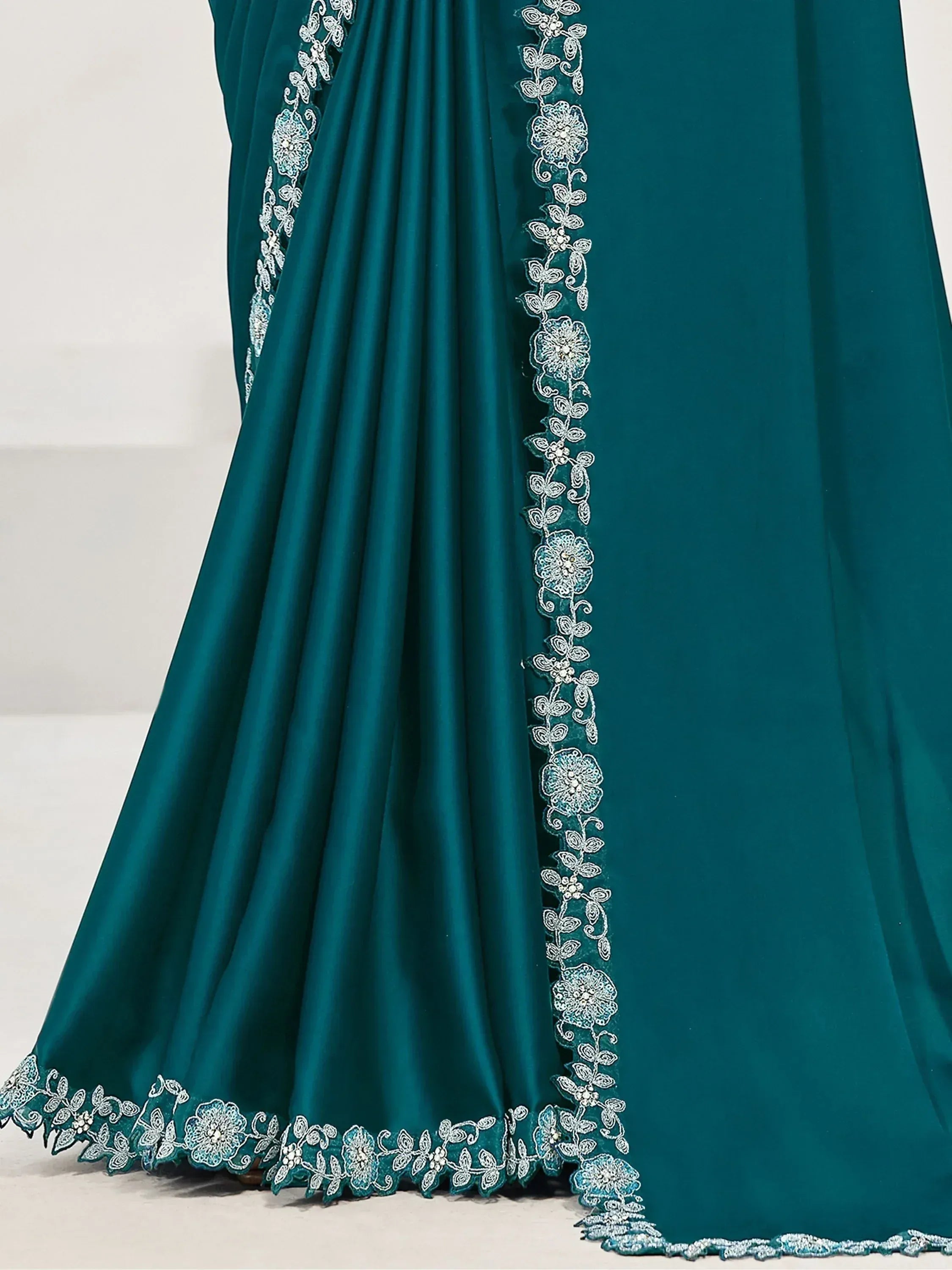 Teal ethnic gown with silver floral embroidery and lace detailing for festive occasions