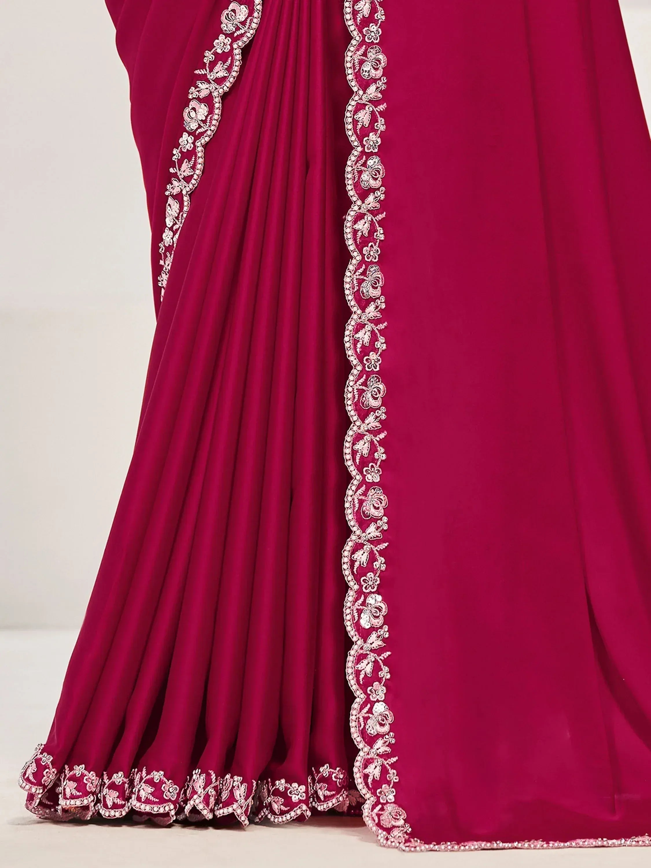 Magenta ethnic gown with floral embroidery and pleated skirt, perfect for Indian weddings or festive occasions.