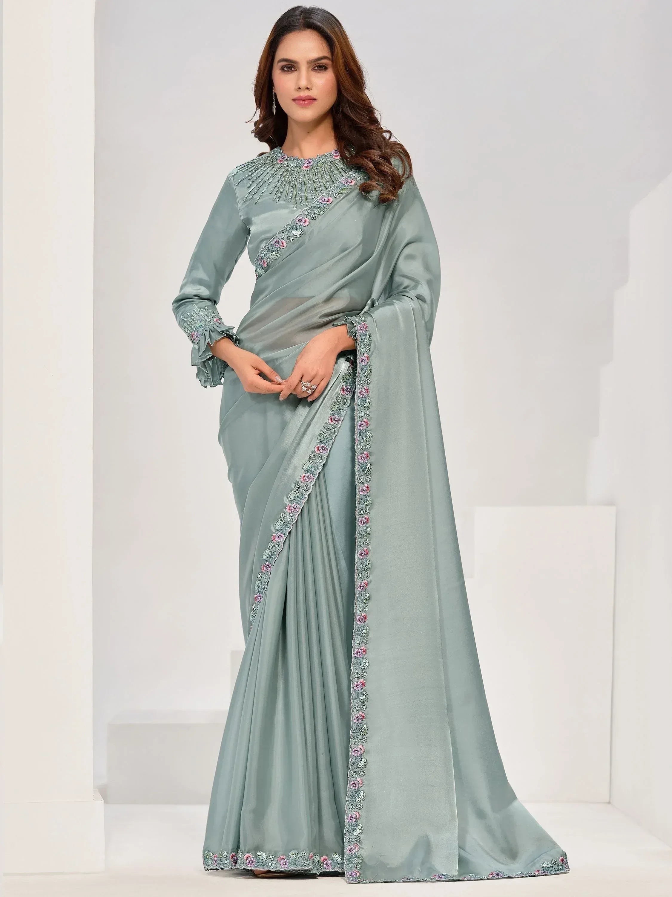 Elegant sage green saree with floral embroidery and ruffled sleeves, perfect for Indian ethnic occasions.