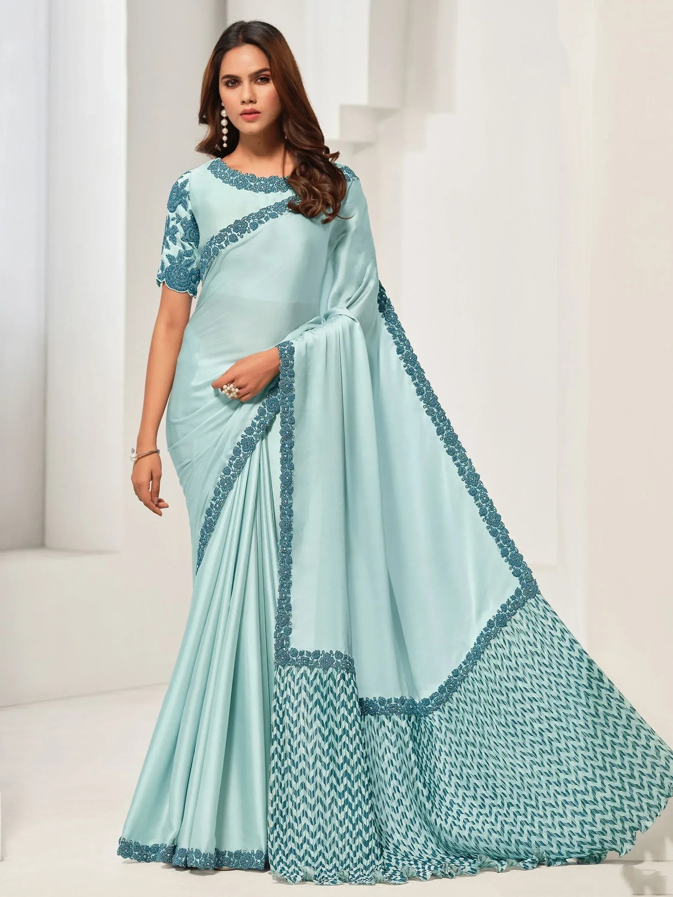 Light blue designer saree with embroidered border and patterned pallu, perfect for ethnic occasions
