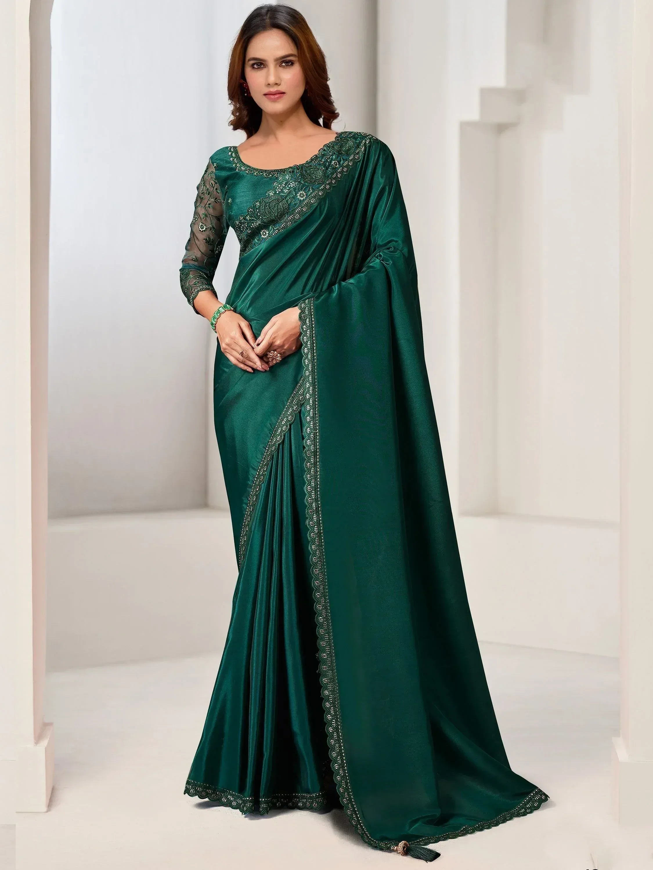 Emerald green satin saree with embroidered blouse and border, elegant Indian ethnic wear