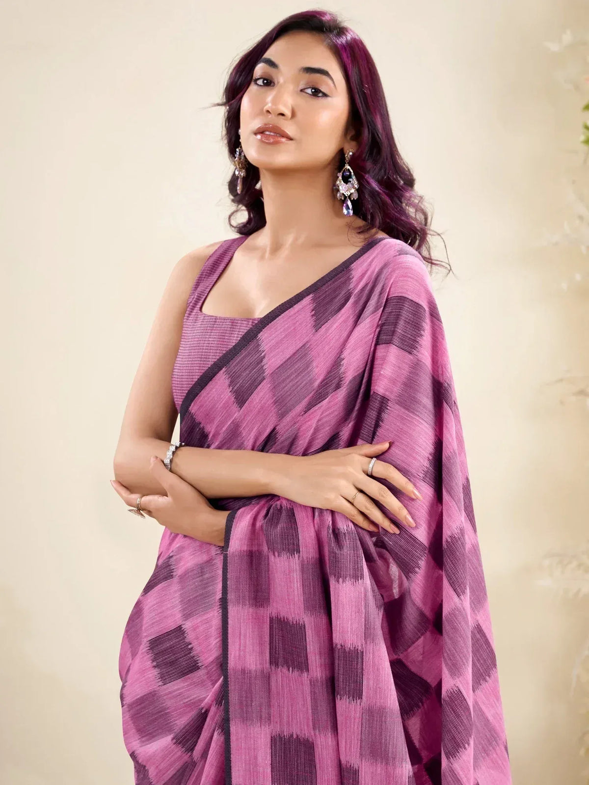 Woman in purple geometric patterned saree with matching blouse, elegant ethnic wear for women
