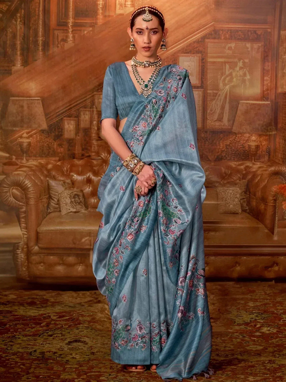 Elegant blue floral embroidered saree with traditional Indian jewelry for festive occasions