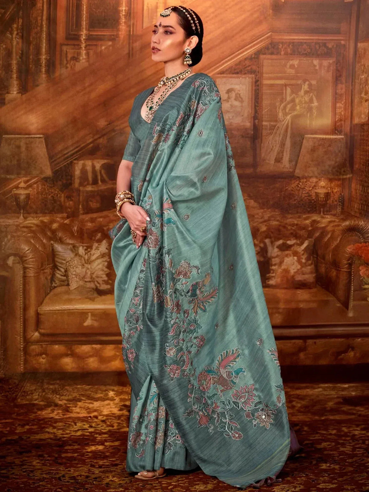 Teal designer saree with floral and bird embroidery, perfect for Indian ethnic wear occasions.