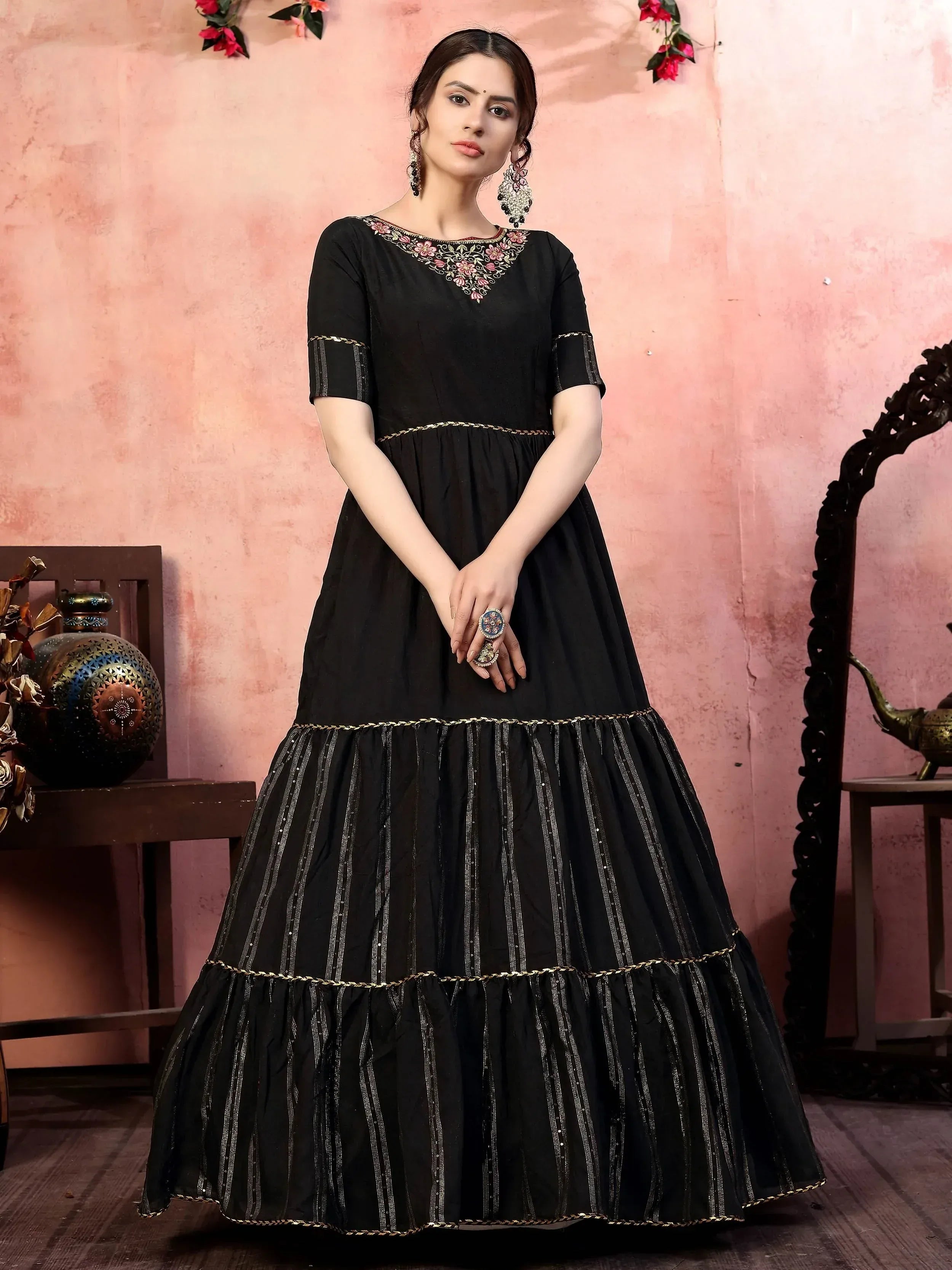 Black ethnic gown with floral embroidery and gold trim, perfect for Indian occasions