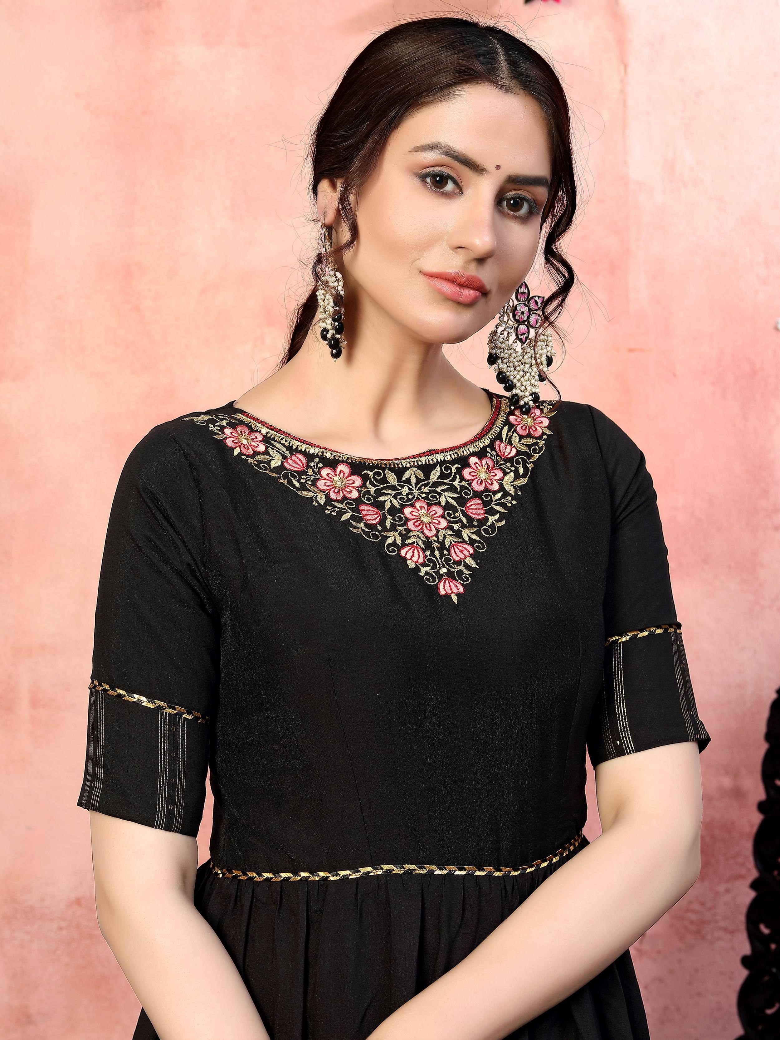 Black ethnic gown with pink floral embroidery and gold detailing, perfect for Indian occasions.