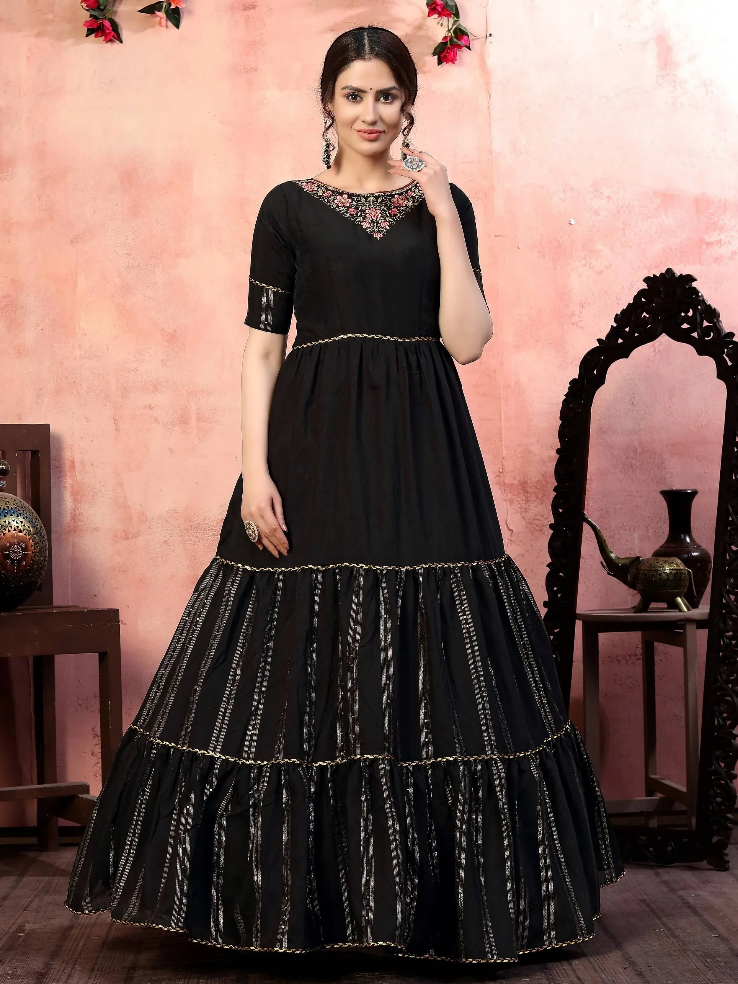 Black embroidered ethnic gown with tiered skirt and gold detailing, perfect for Indian occasions.